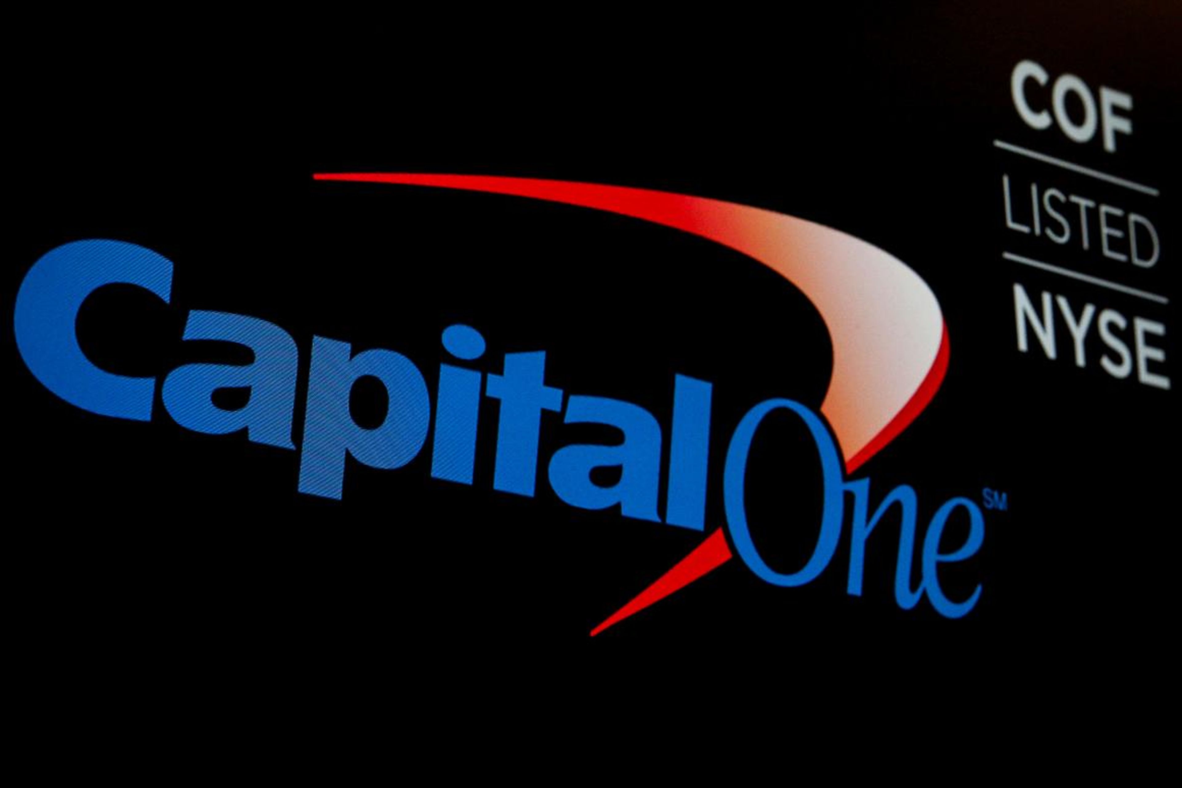 The logo and ticker for Capital One displayed on a screen on the floor of the New York Stock Exchange.