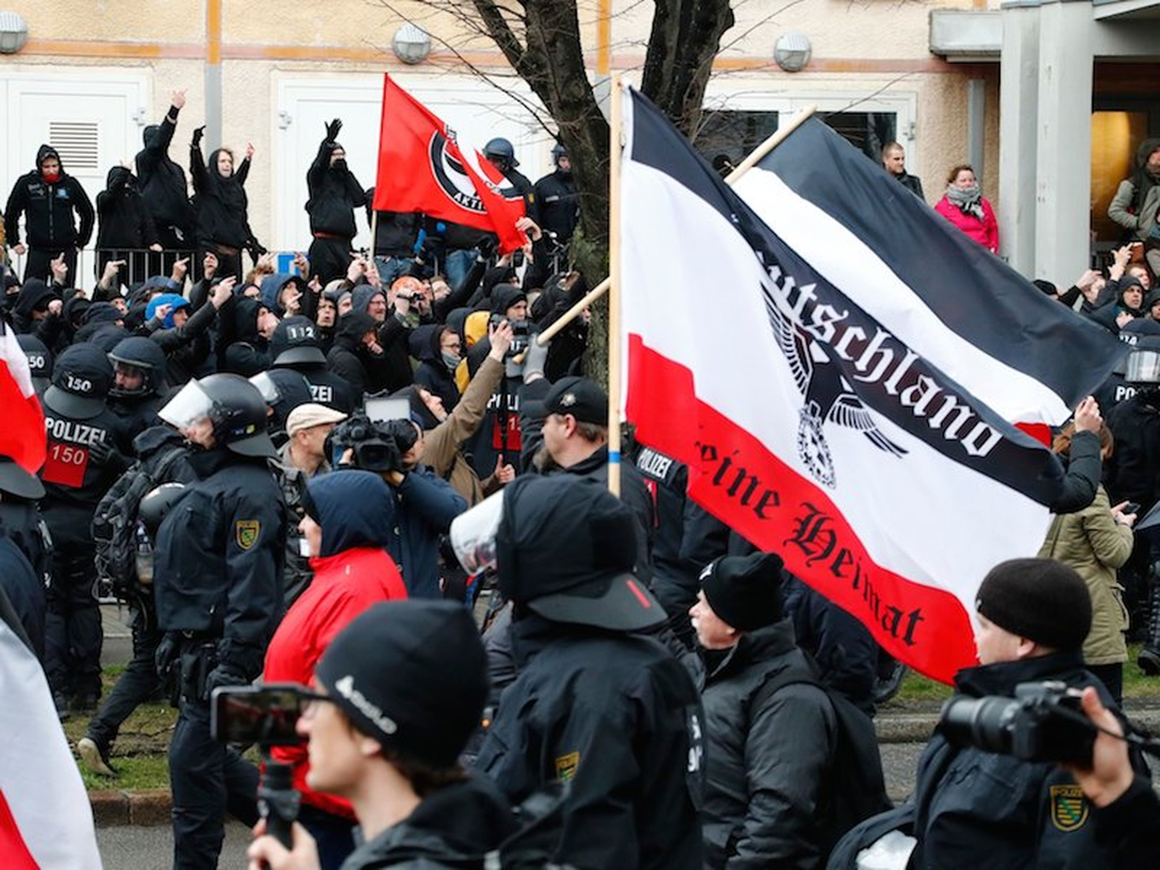 Manifestantes a favor del partido "Die Rechte" pasan frente a manifestantes contra el movimiento neonazi en Leipzig (Alemania) en marzo de 2017.