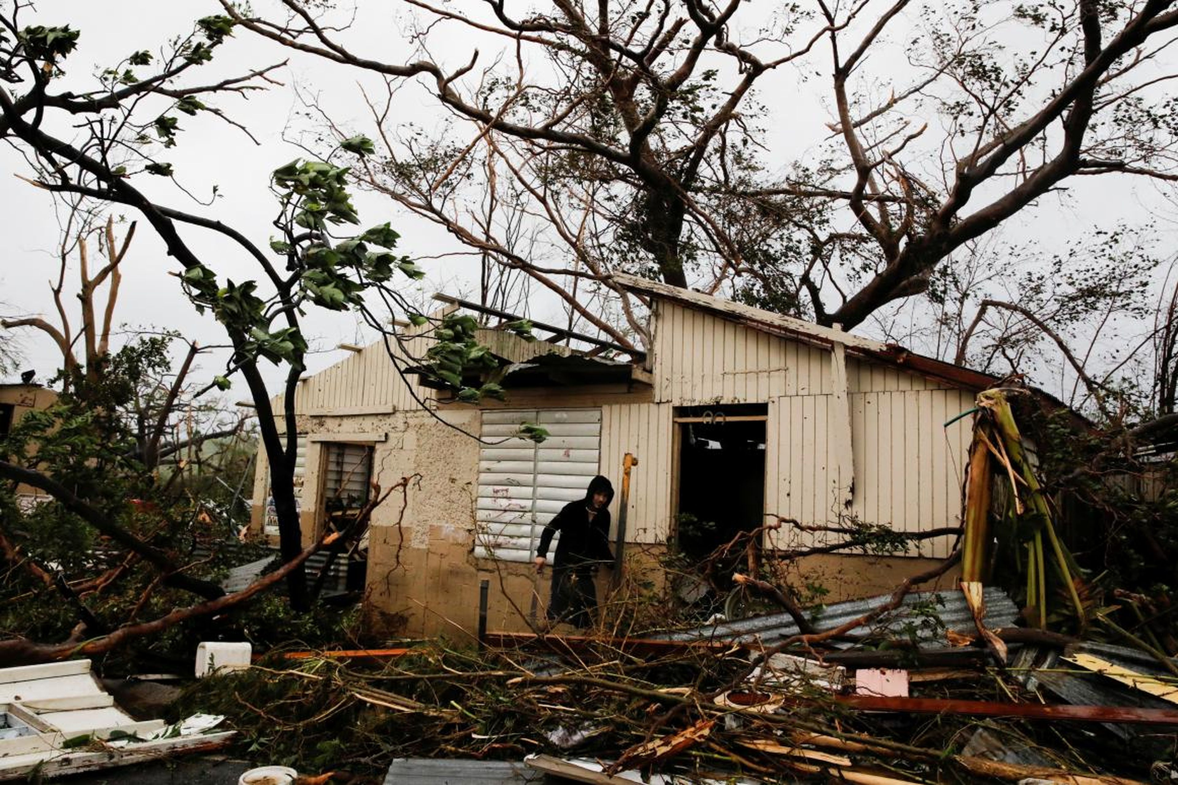 A man looks for valuables in the damaged house of a relative after the area was hit by Hurricane Maria in Guayama, Puerto Rico, on September 20, 2017.