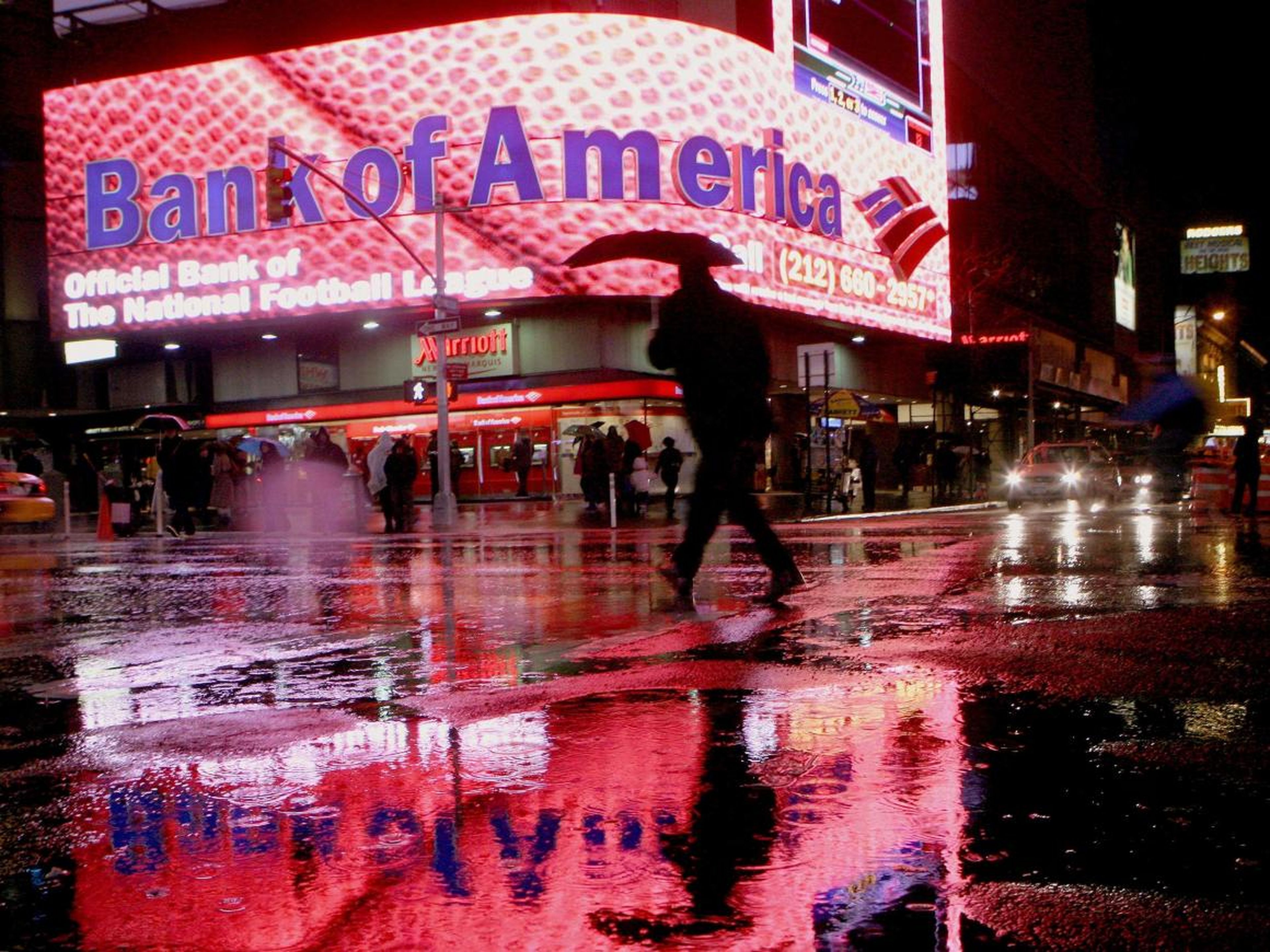 A man walks near a Bank of America branch in New York's Times Square Decemeber 11, 2008.