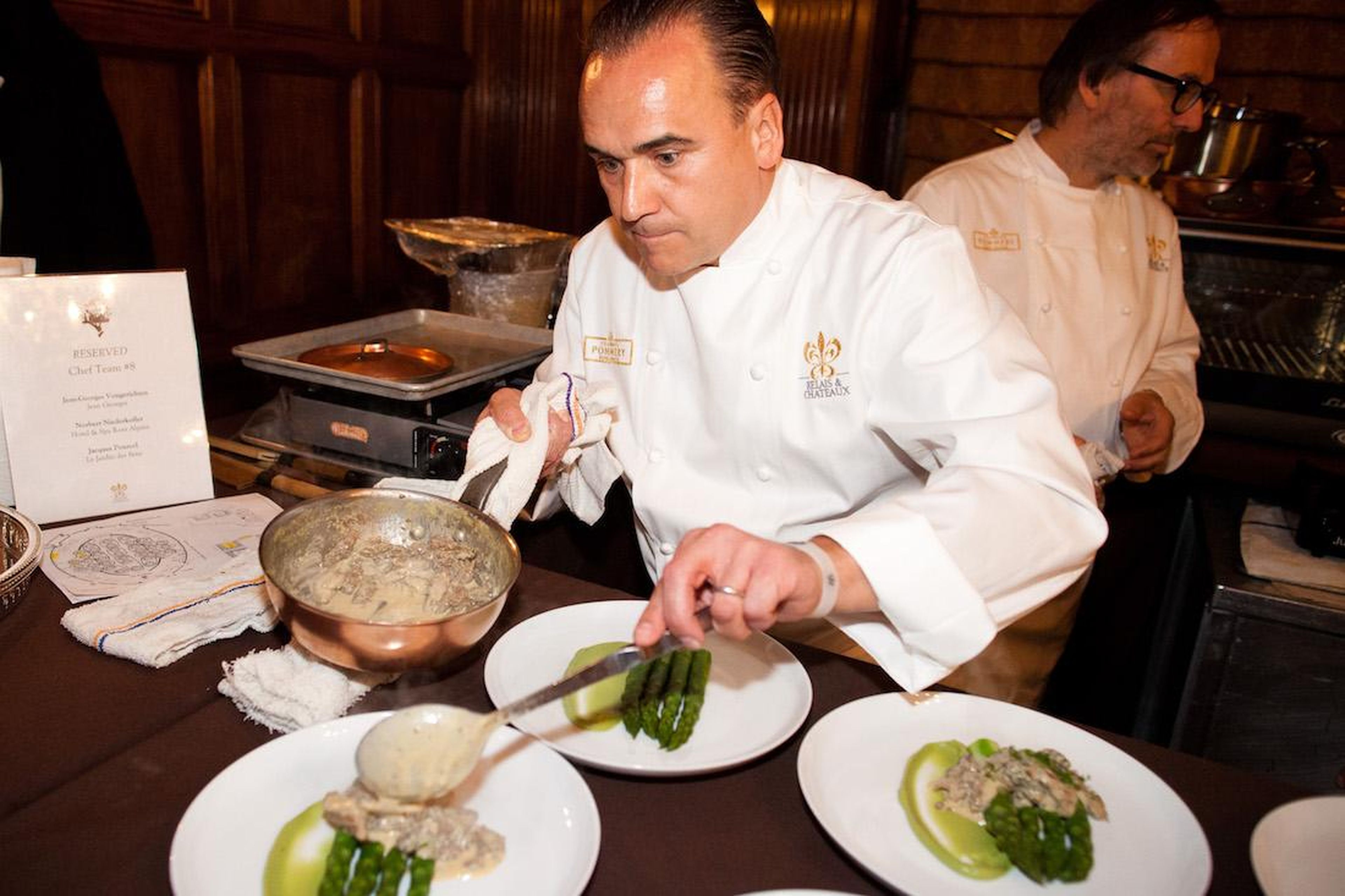 French chef Jean-Georges Vongerichten plates a dish for service during the 2012 Grands Chefs Dinner in New York.
