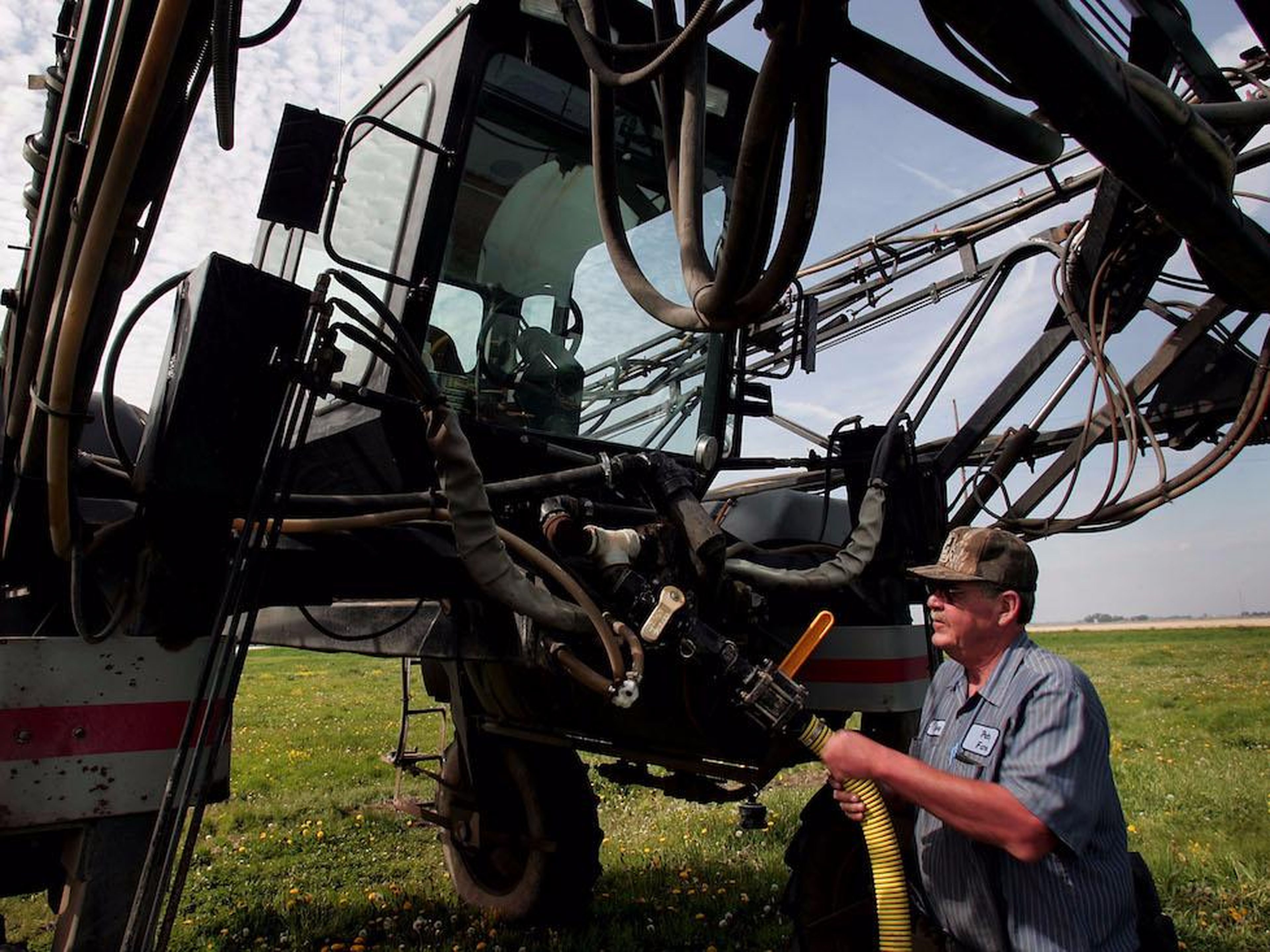 A farmer loads herbicide into a sprayer in Illinois.
