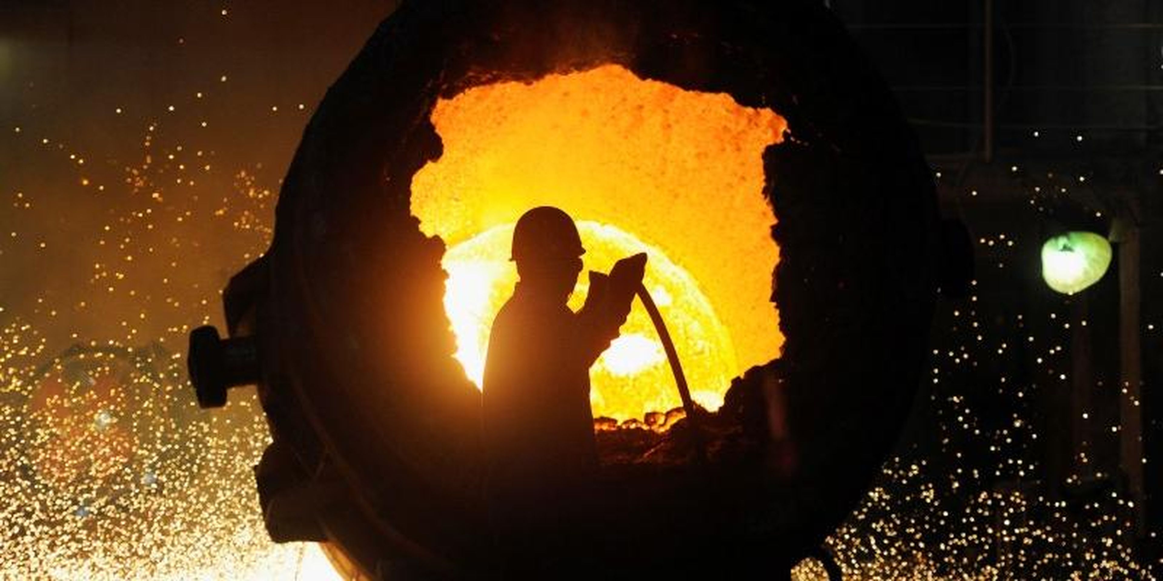 FILE PHOTO: A worker operates a furnace at a steel plant in Hefei