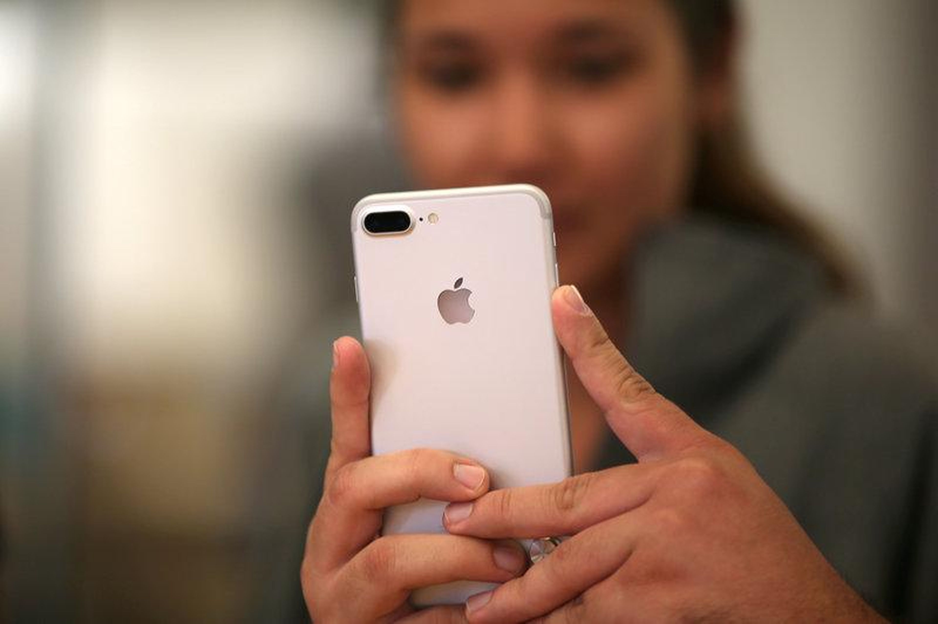 FILE PHOTO: A customer views the new iPhone 7 smartphone inside an Apple Inc. store in Los Angeles