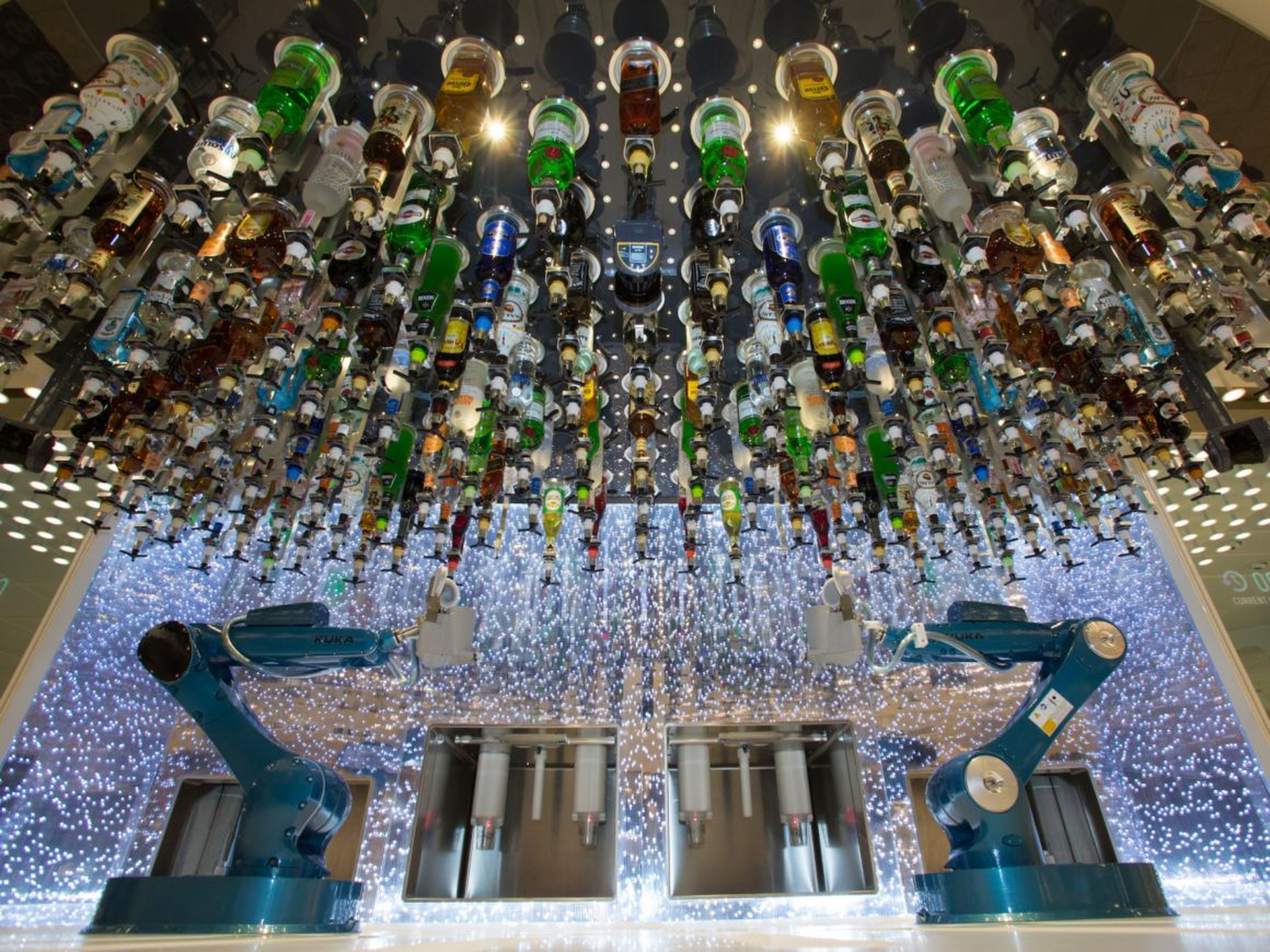At the Bionic Bar, robot bartenders serve passengers drinks.