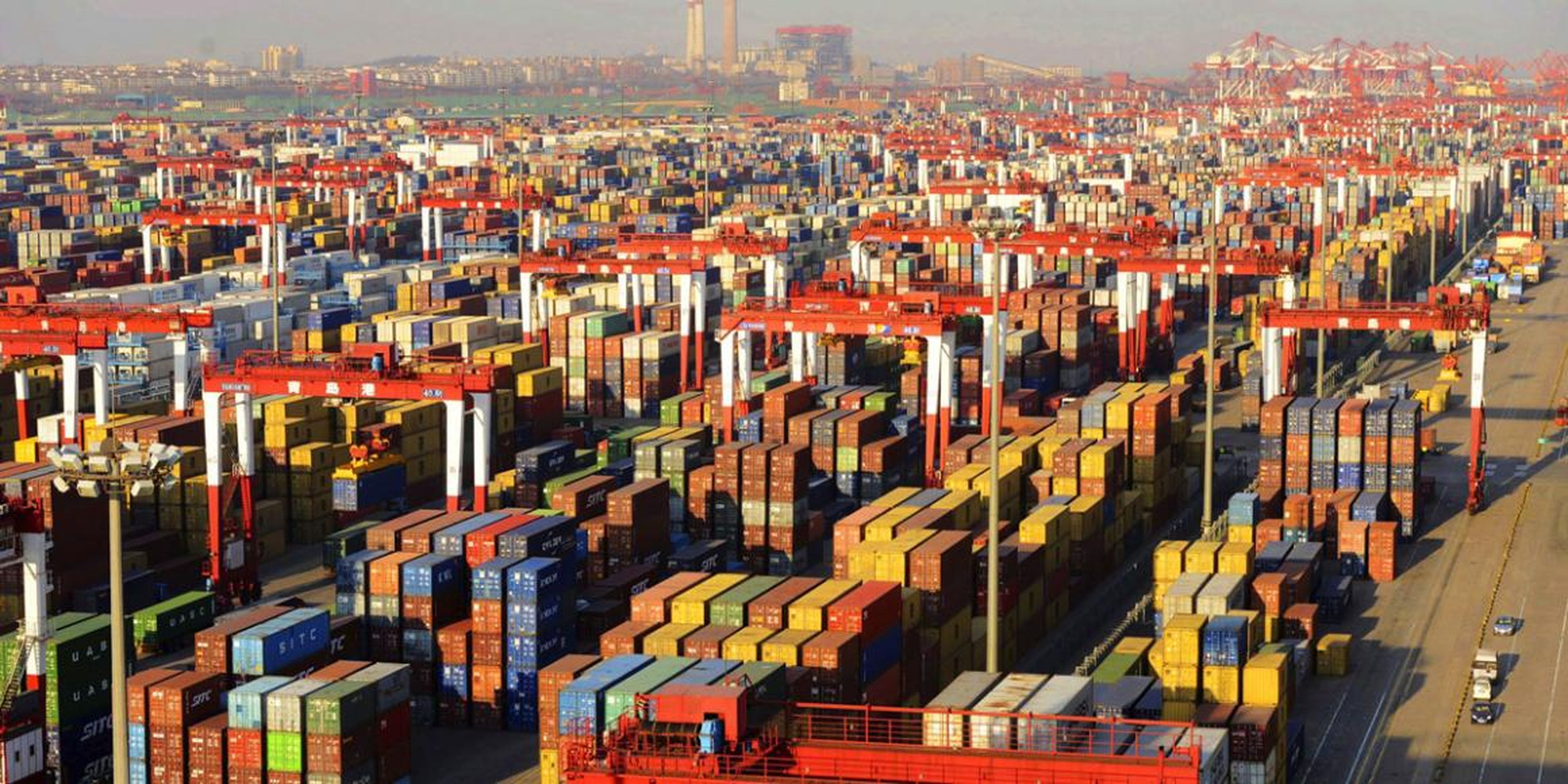 Shipping containers are seen piled up at a port in Qingdao, Shandong province December 10, 2013.