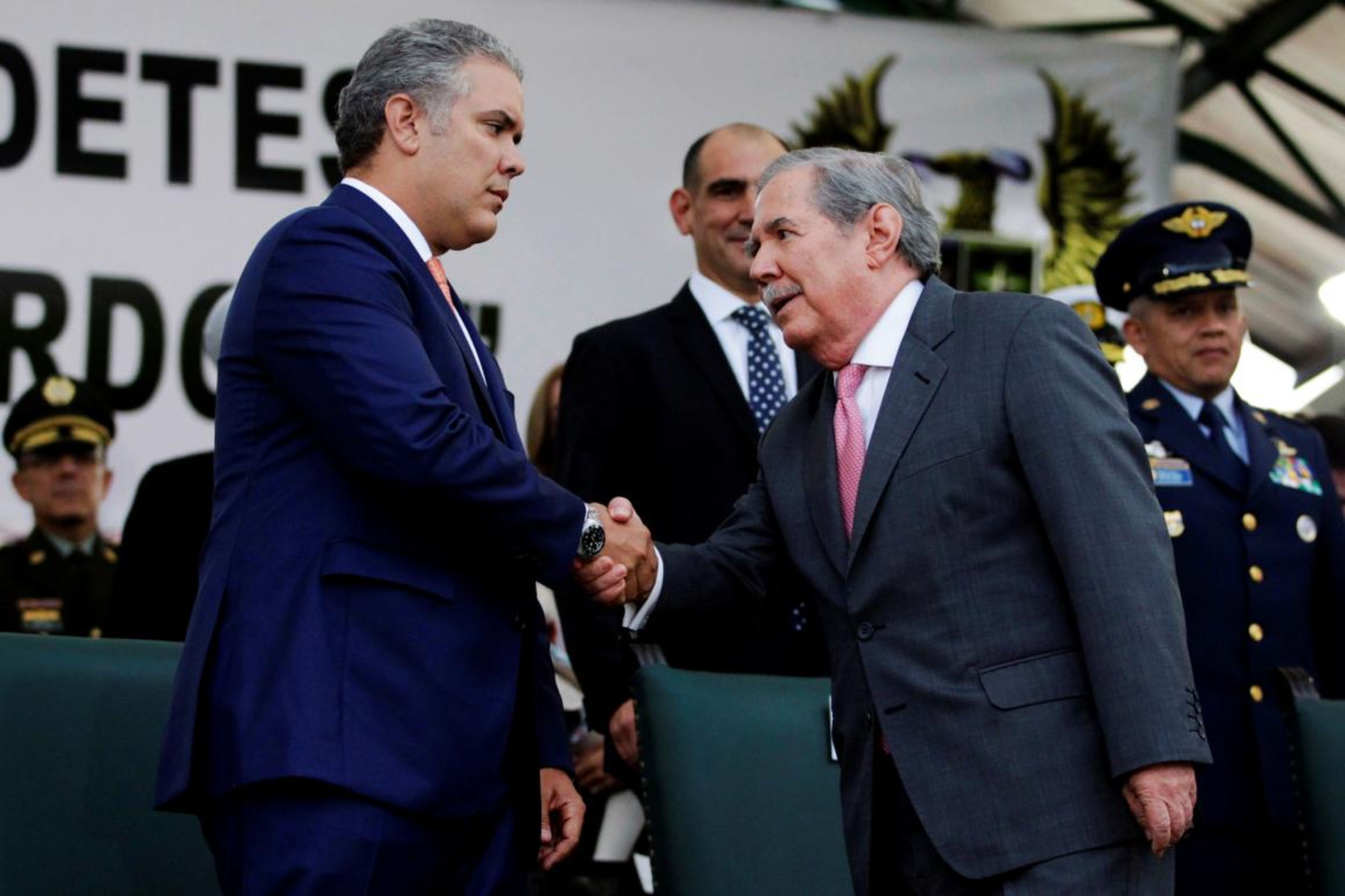 Colombian President Ivan Duque and Defense Minister Guillermo Botero shake hands on August 14, 2018.