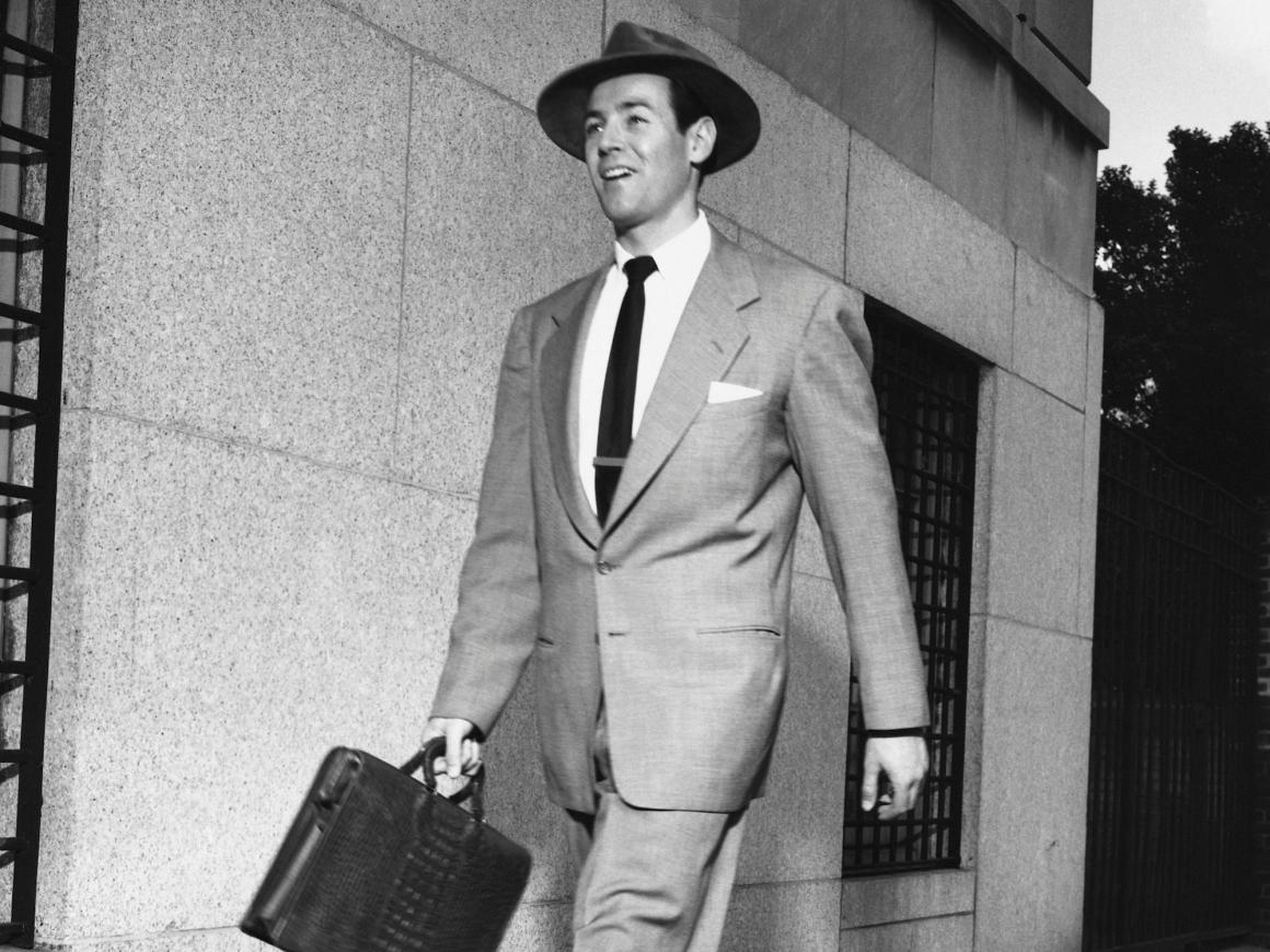 Generally speaking, men sported suits, ties, and overcoats. "Dark suits, white shirts, dark ties, and white pocket squares didn't just dominate — they were practically a requirement in business," according to GQ.