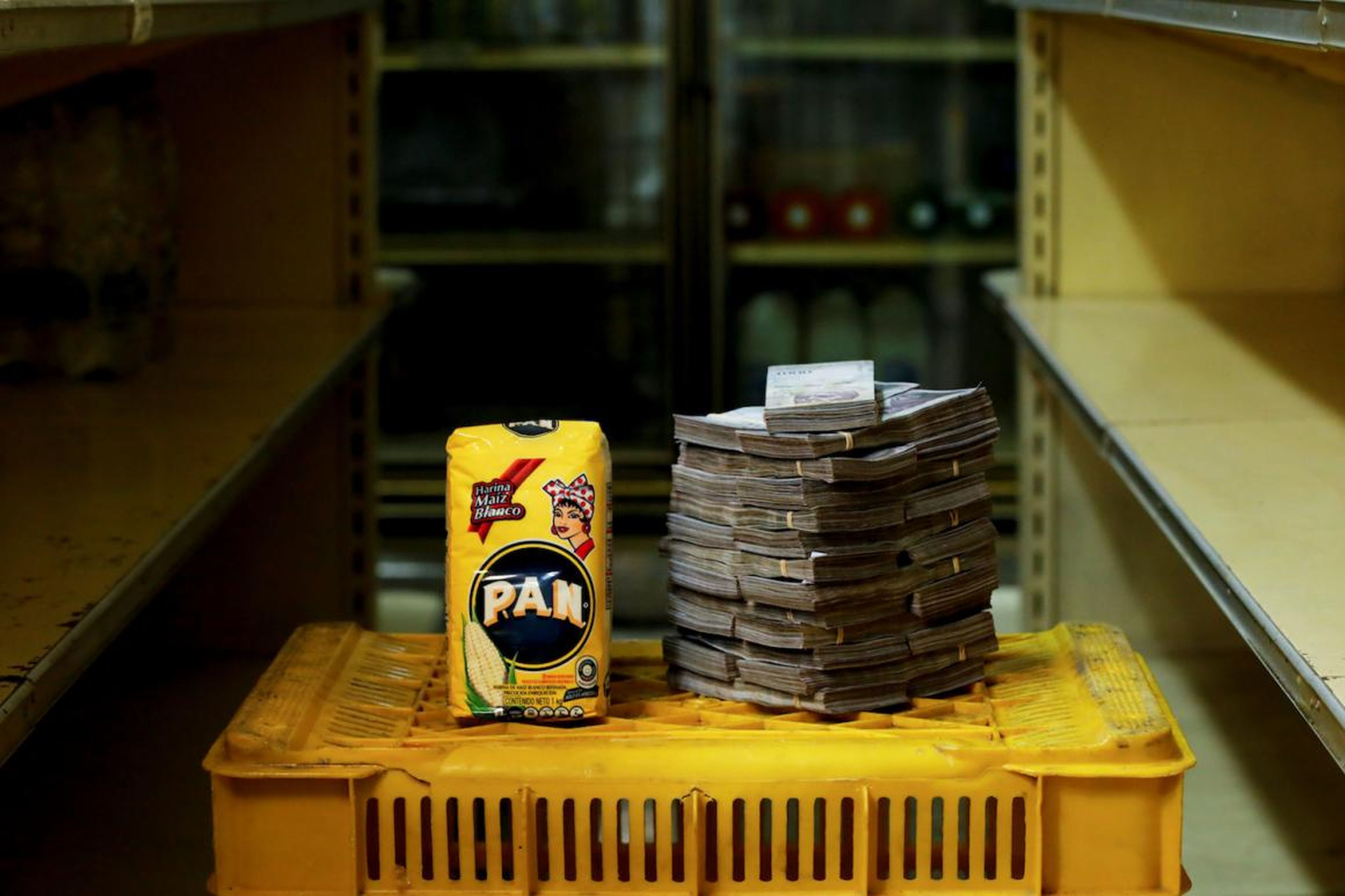 A package of 1kg of corn flour is pictured next to 2,500,000 bolivars, its price and the equivalent of 0.38 USD, at a mini-market in Caracas, Venezuela.