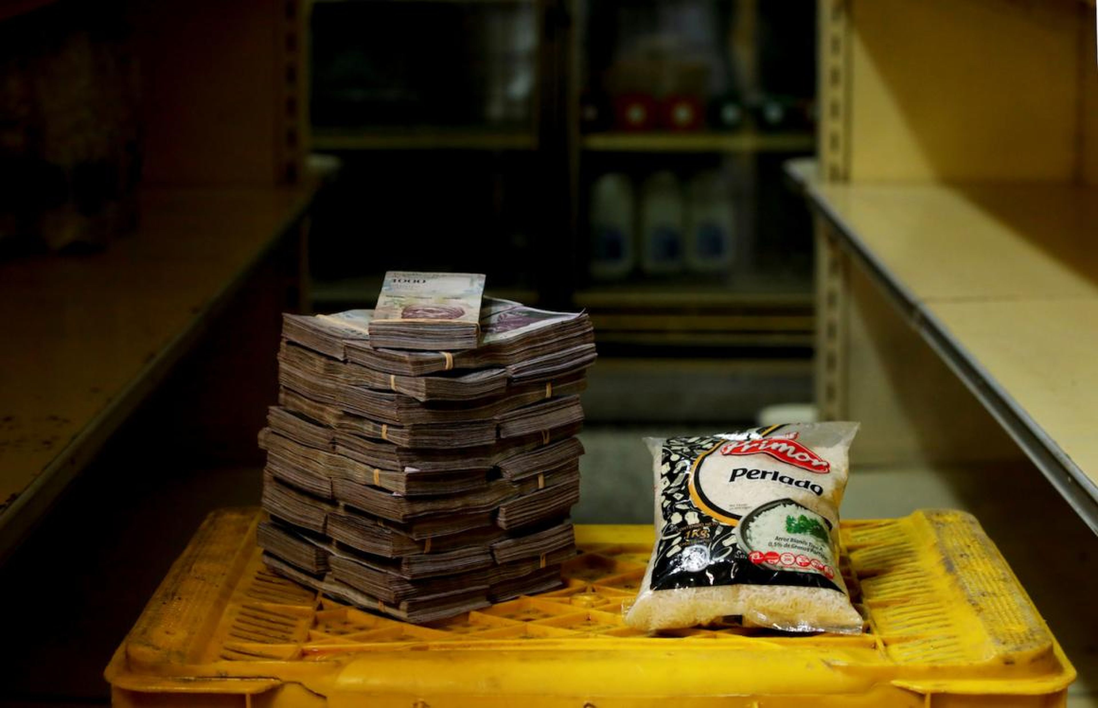 A package of 1kg of rice is pictured next to 2,500,000 bolivars, its price and the equivalent of 0.38 USD, at a mini-market in Caracas, Venezuela.