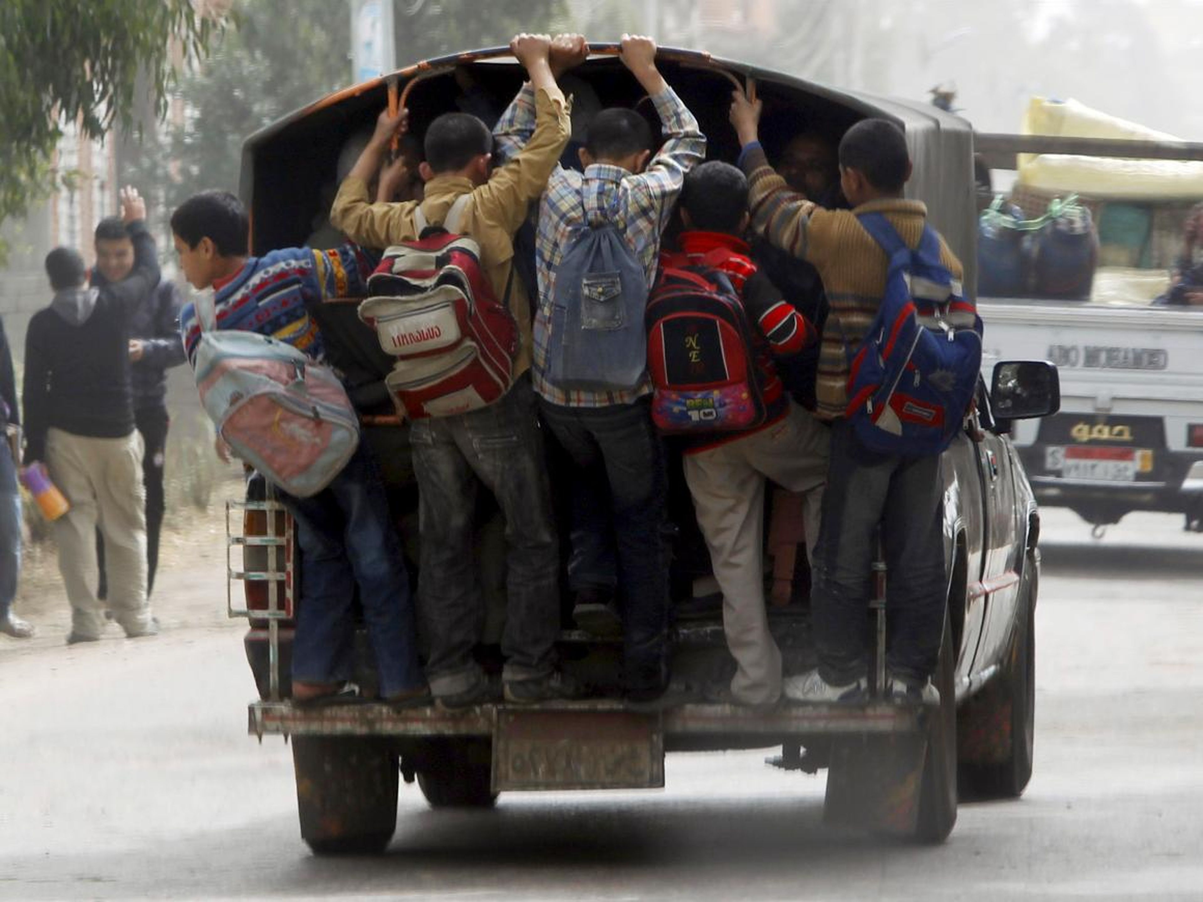 In parts of Cairo, Egypt, "school buses" involve kids piling into and hanging off the back of ordinary trucks.