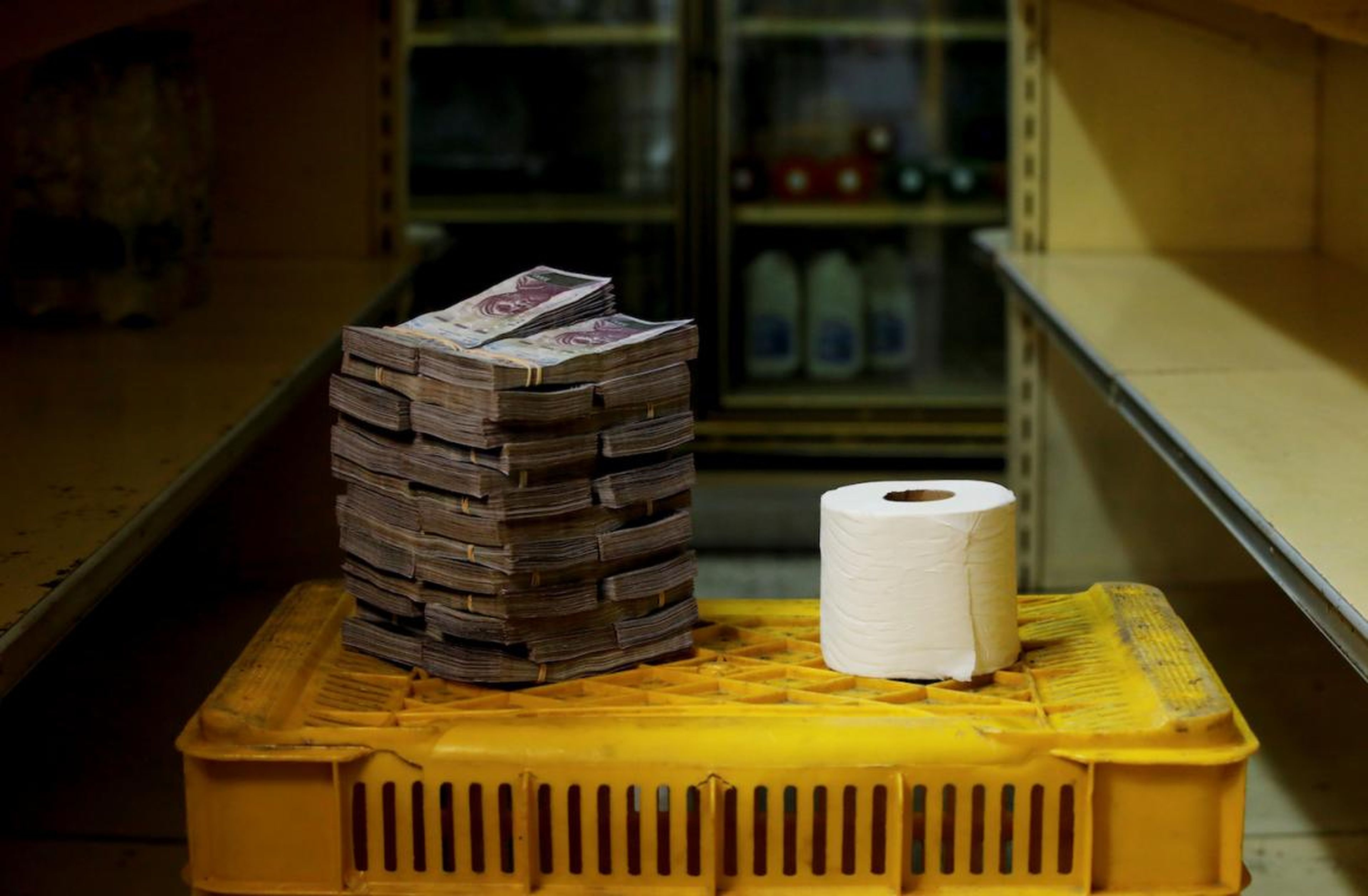 A toilet paper roll is pictured next to 2,600,000 bolivars, its price and the equivalent of 0.40 USD, at a mini-market in Caracas, Venezuela.