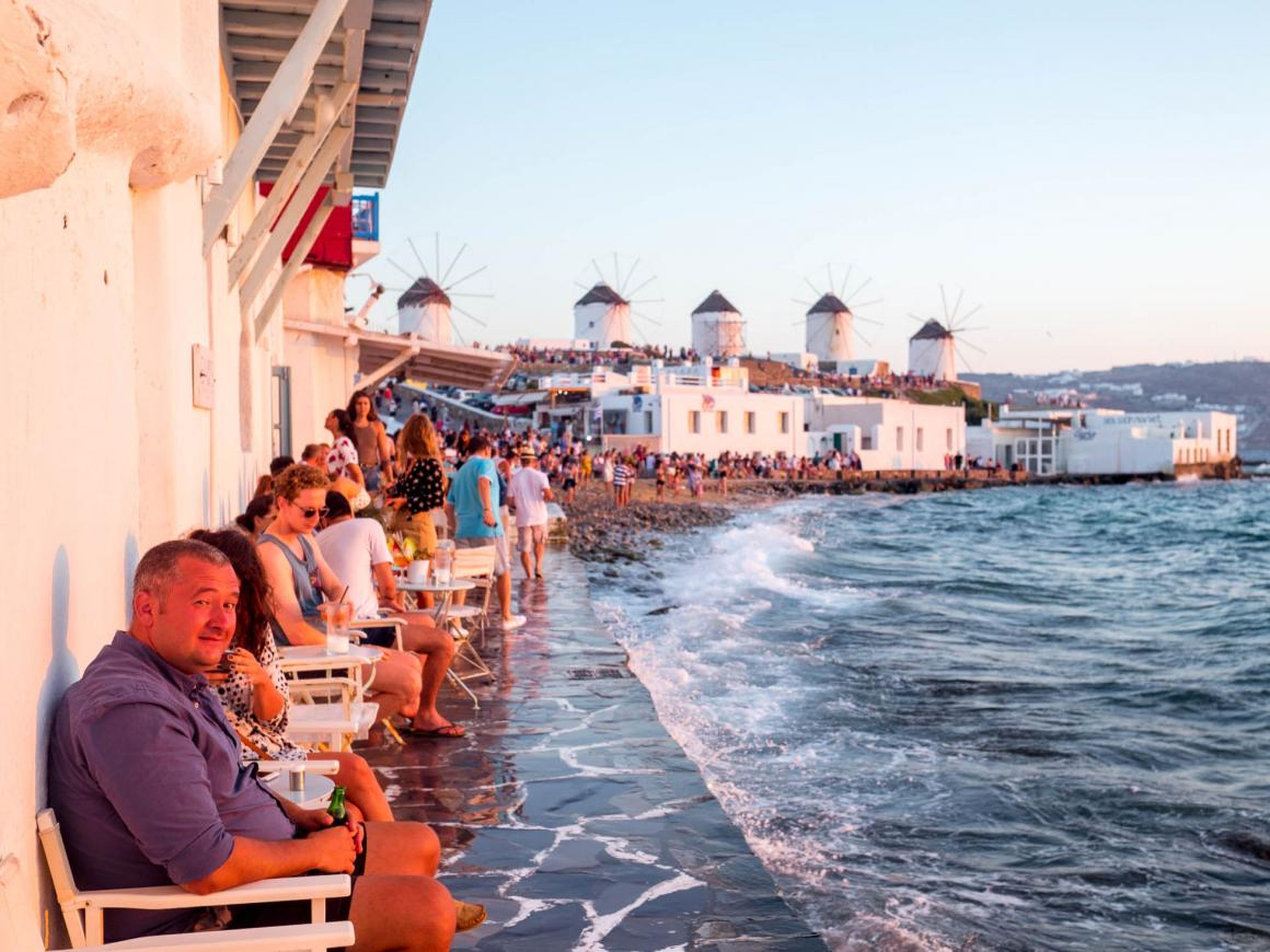 The most popular place to watch the sunset in Mykonos is Little Venice, a row of fishing houses that line the waterfront. The area has been converted into restaurants and bars, with chairs overlooking the surf.