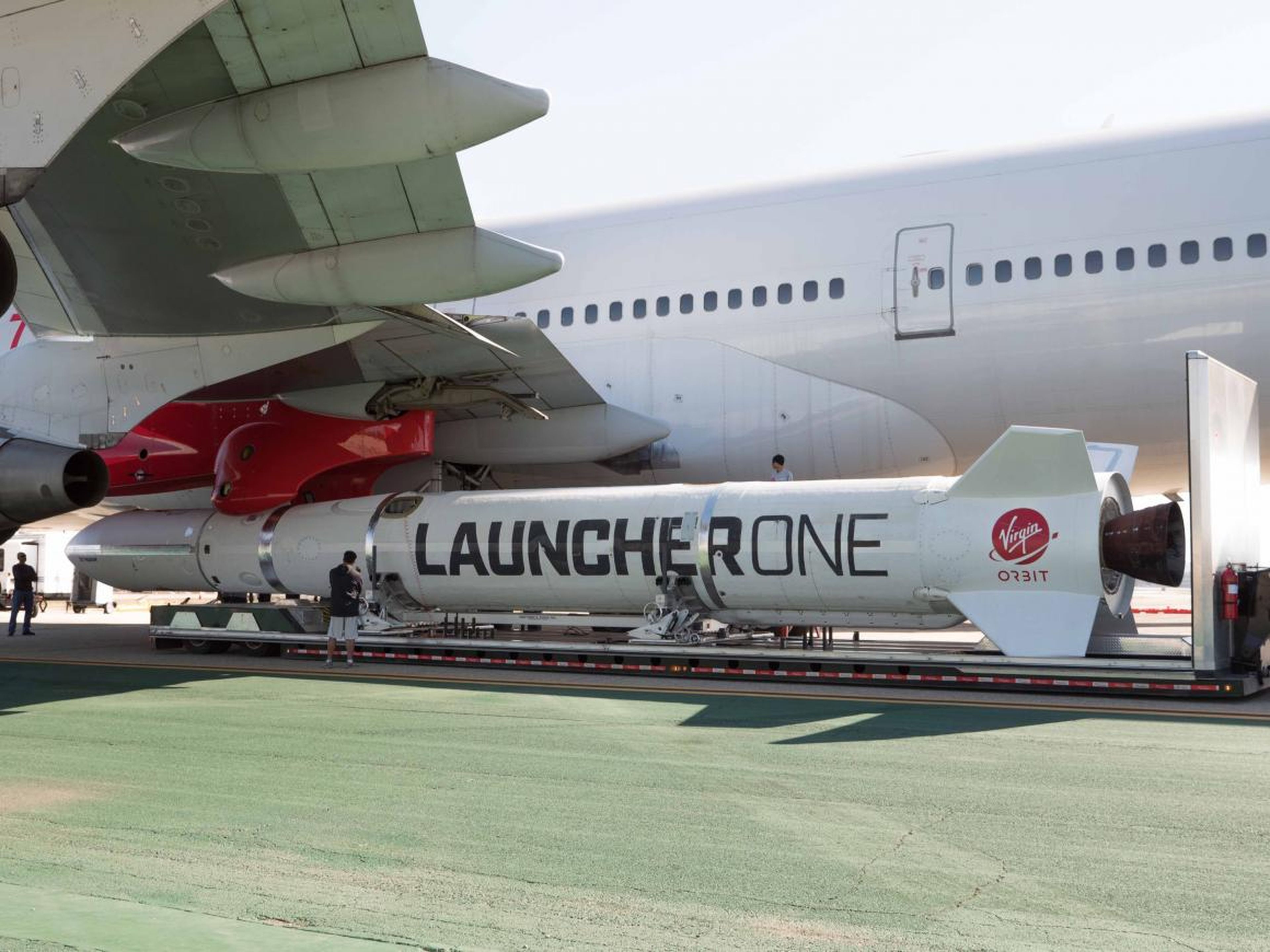 Virgin Orbit's LauncherOne raised up to the port-side wing of Cosmic Girl.