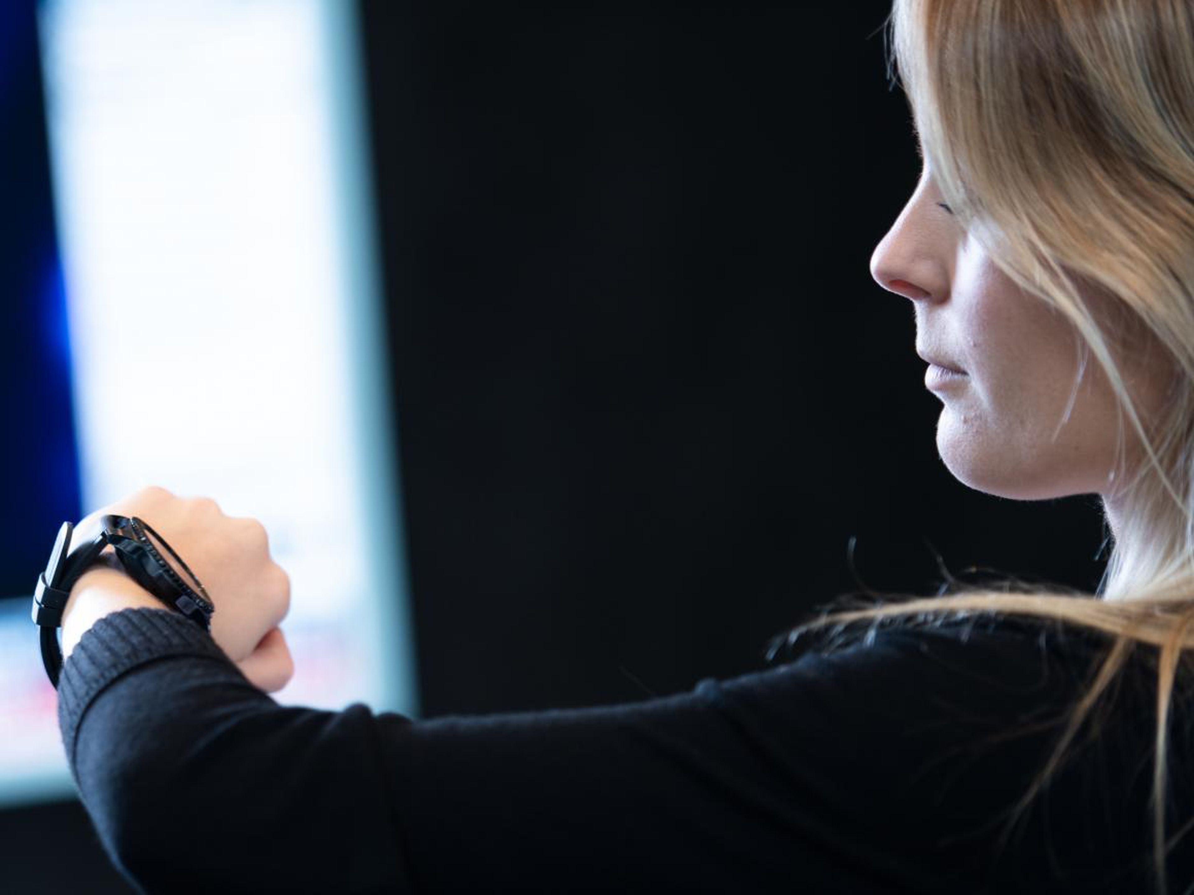 An employee looks at her Samsung Gear S3 watch.