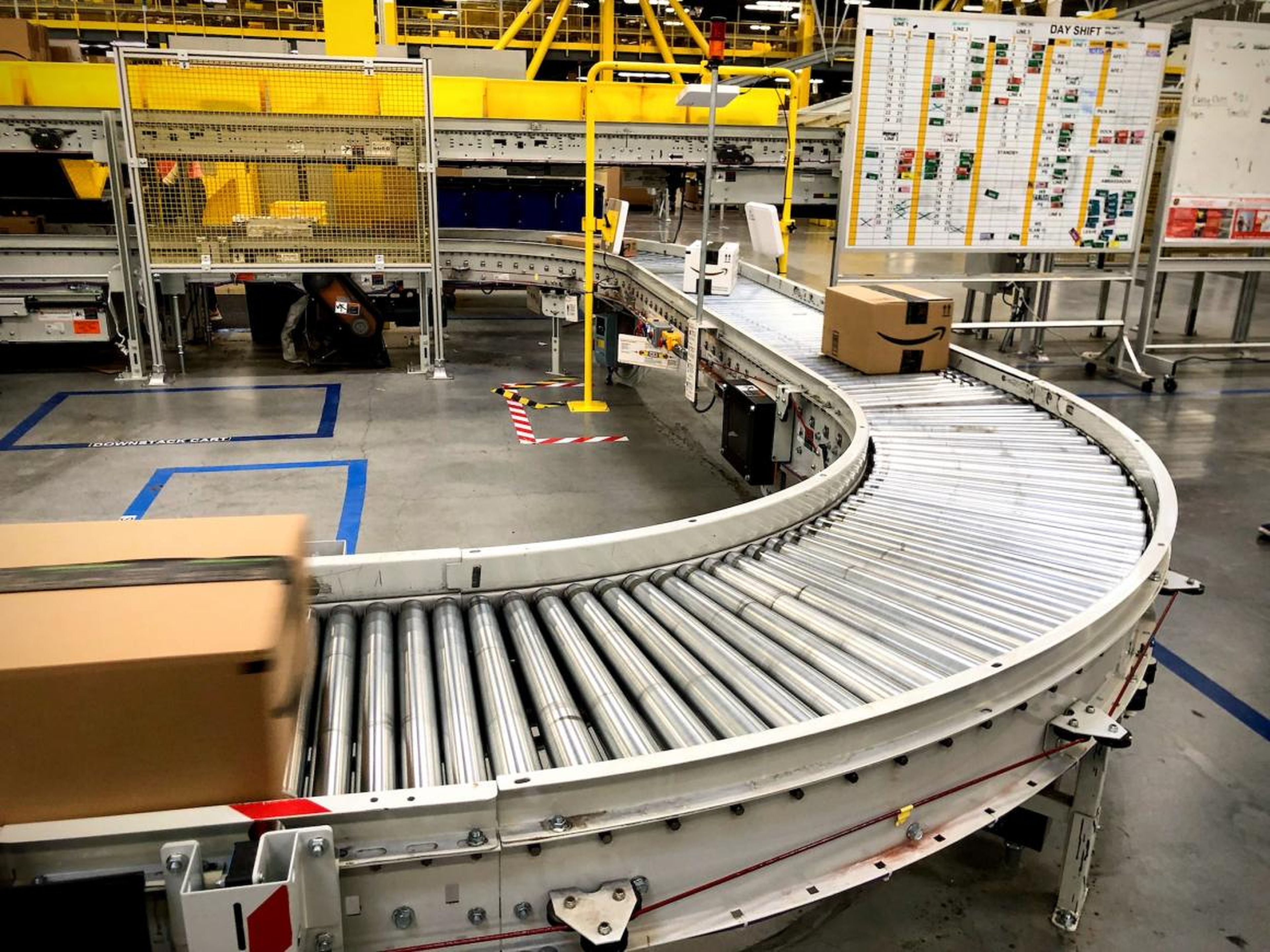 Employees will take a bin off the belt, scan it, and unpack it. Then the system will tell them what type of box they need. An employee will assemble the correct box, fill it, and send it on its way.