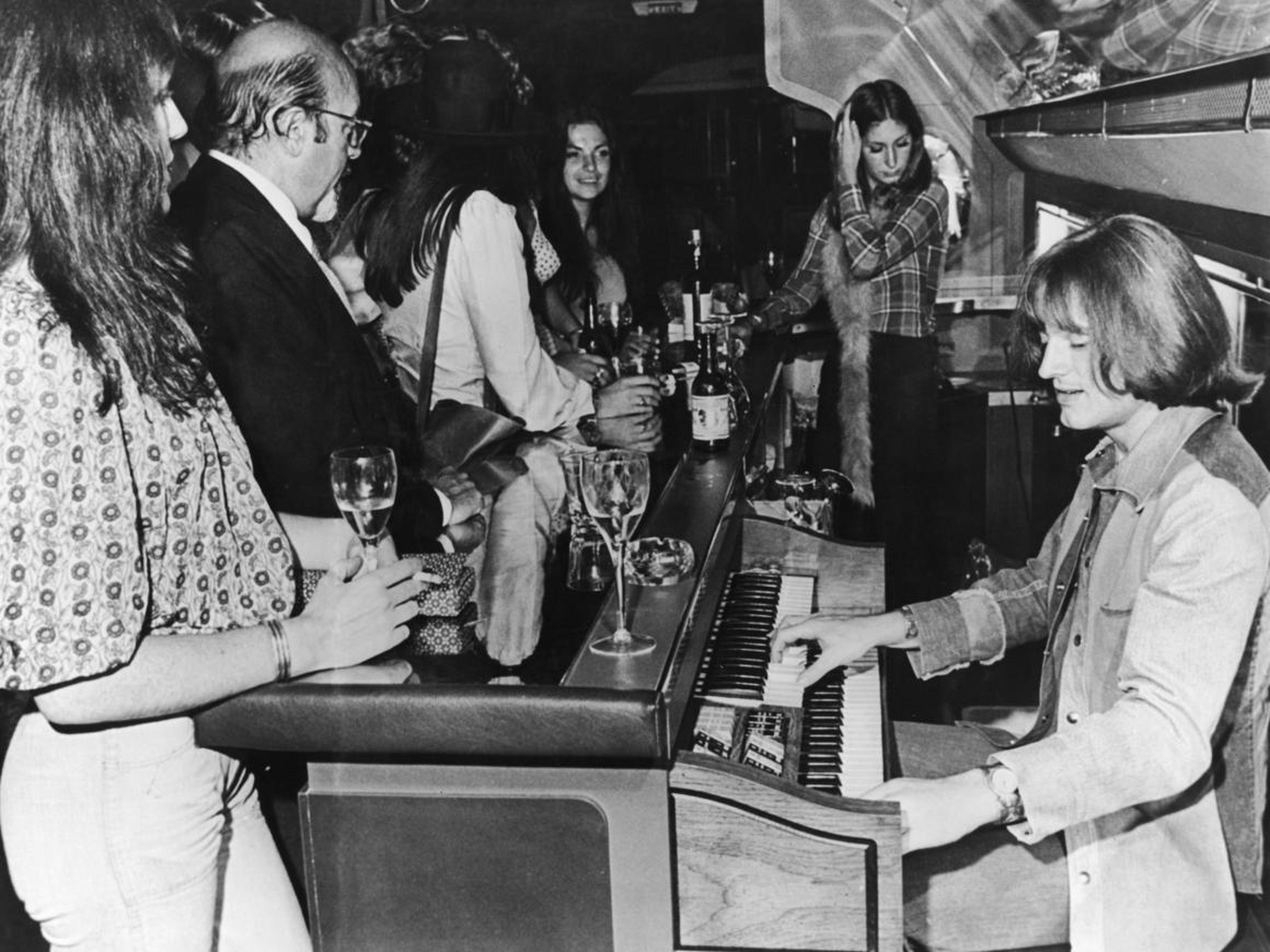 John Paul Jones of Led Zeppelin plays an electric organ behind the bar on "The Starship."