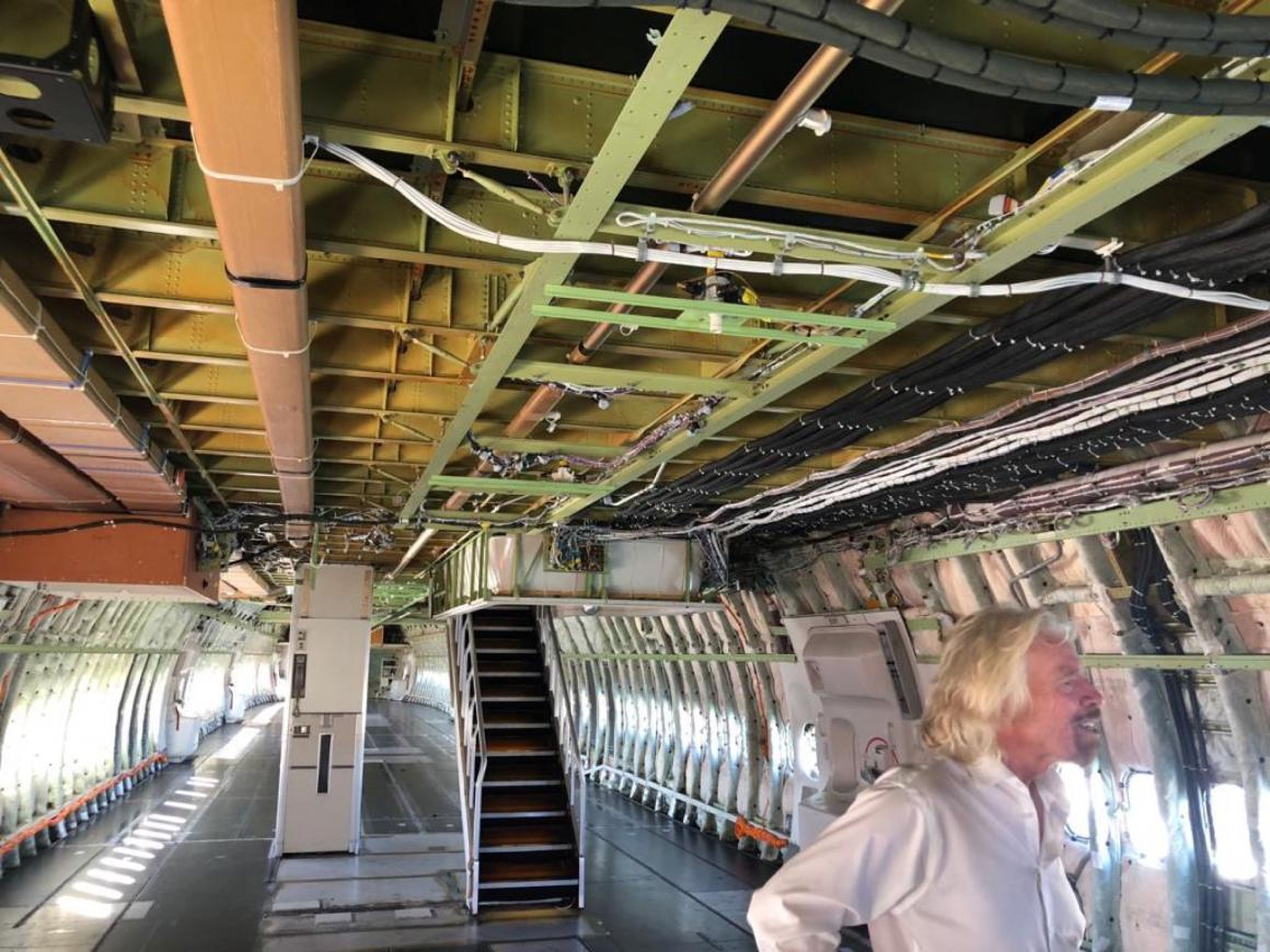 Sir Richard Branson inside Cosmic Girl, which has been stripped down to reduce weight and allow Virgin Orbit to attach LauncherOne to its port-side wing.