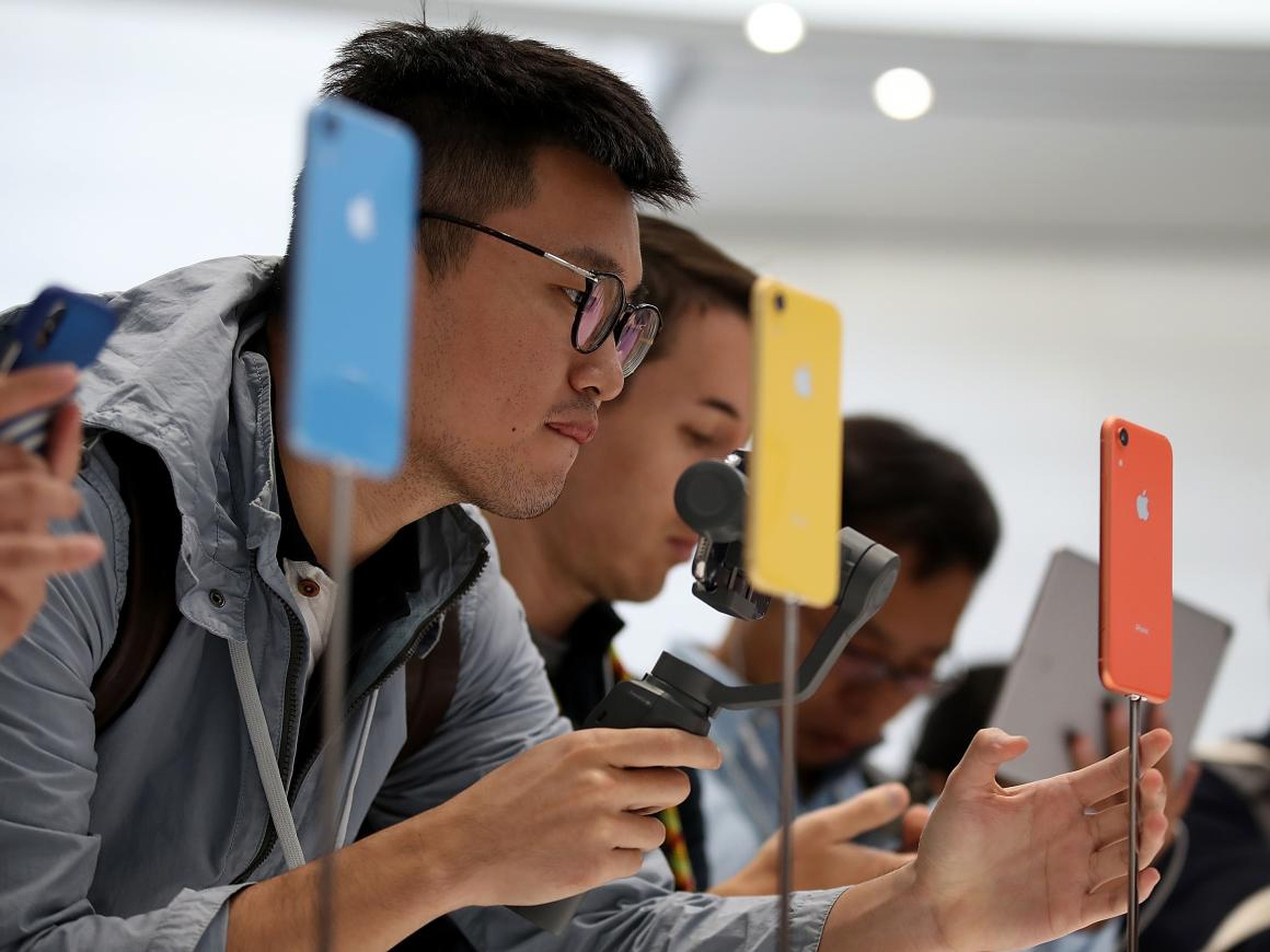 Visitors inspecting the new iPhone XR during an Apple event at the Steve Jobs Theatre on September 12 in Cupertino, California.