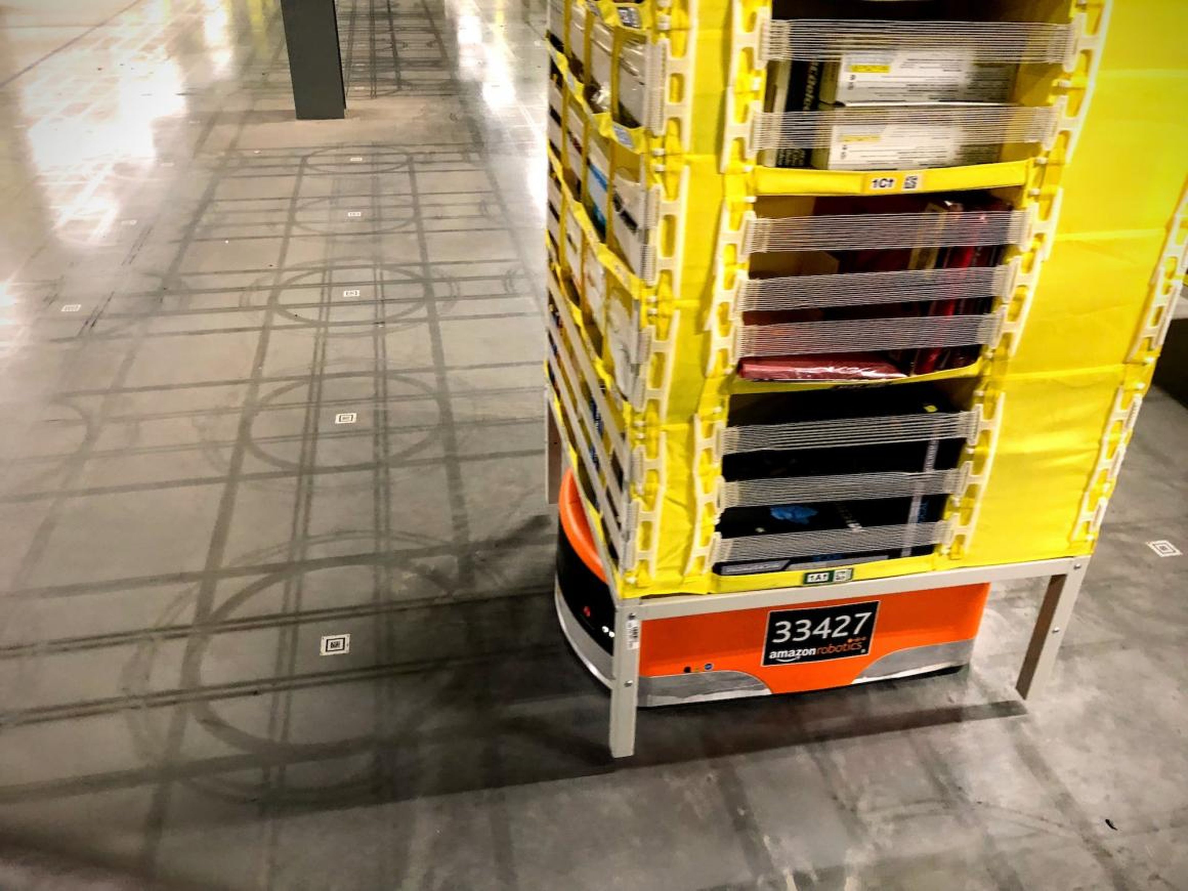 The robots rely on QR codes on the floor to map the room.