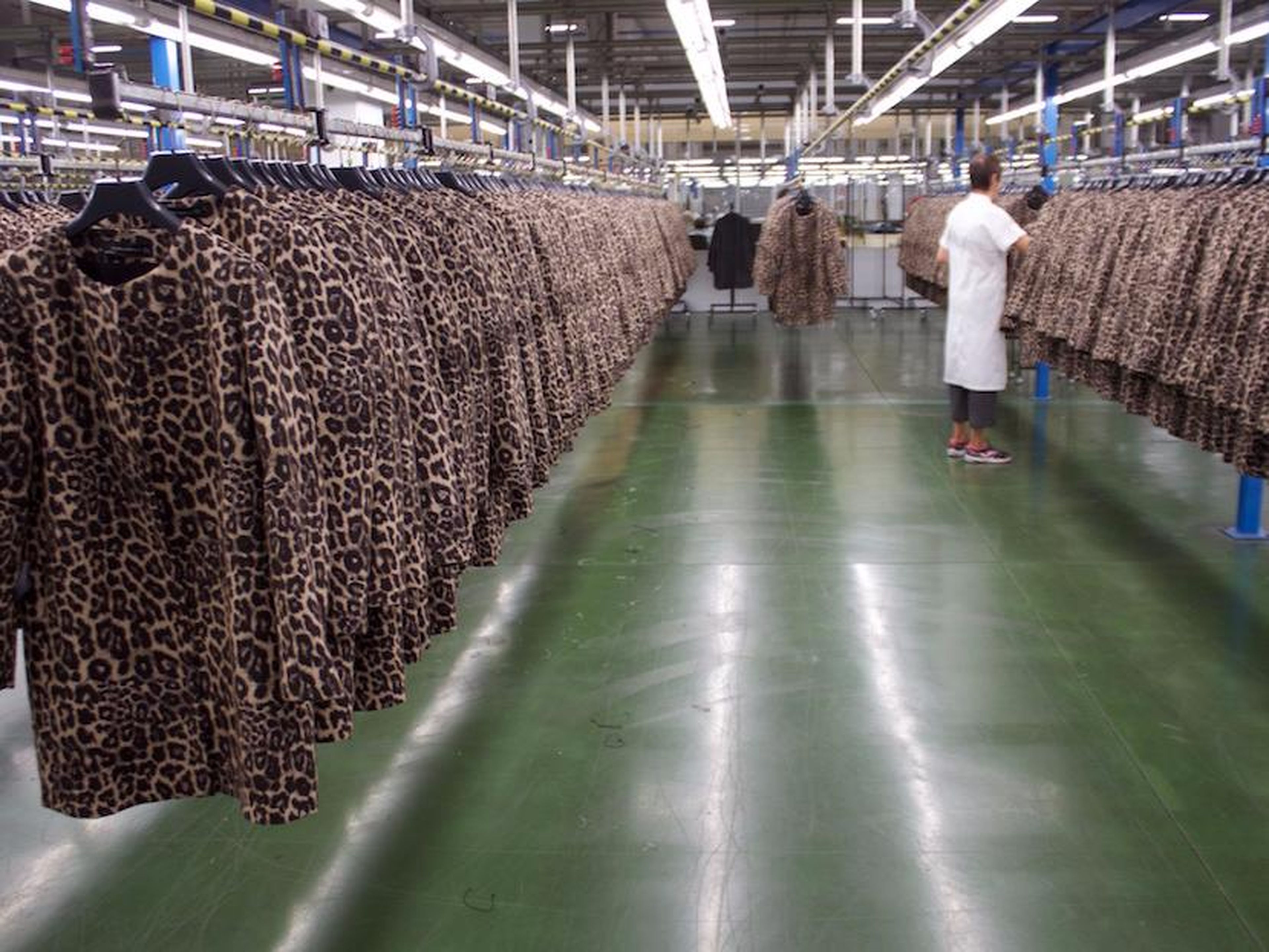 Rows of Zara coats are checked by hand.