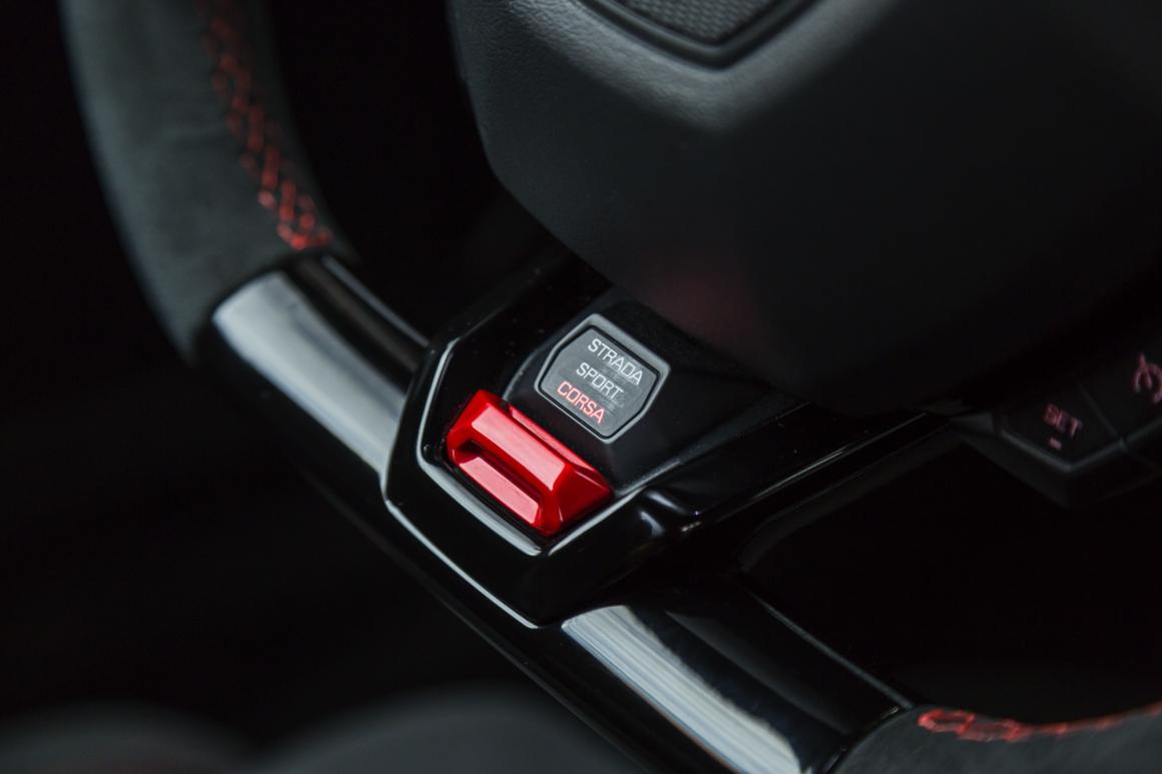 Driving modes are selected using the "anima" switch on the steering wheel. You have "Strada," "Sport," and "Corsa" to choose from.