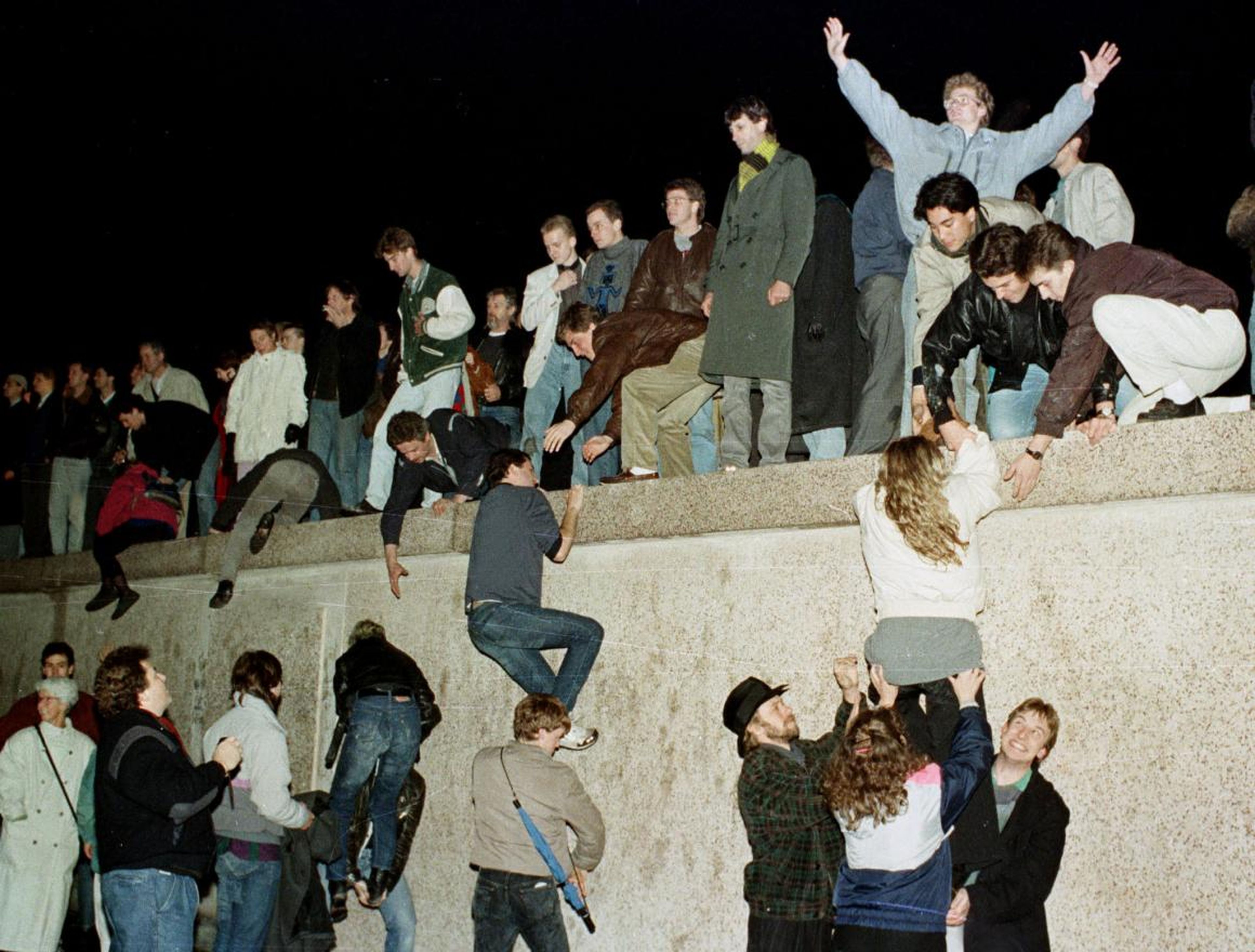 East Germans celebrated as they climbed the Berlin Wall at the Brandenburg Gate.