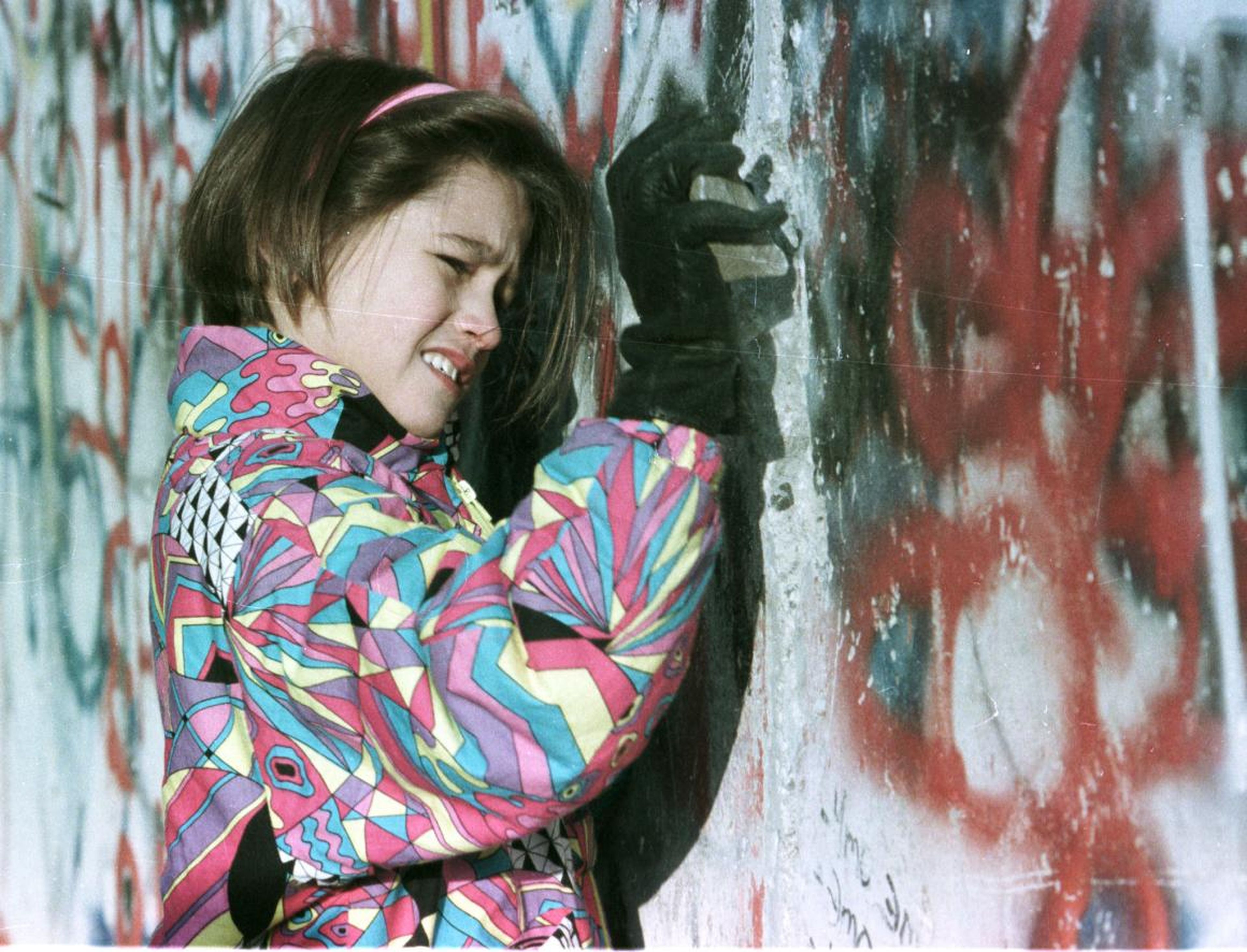 Even days later, citizens wanted to participate in the destruction. Here, a young West German girl hammers the Berlin Wall November 19.