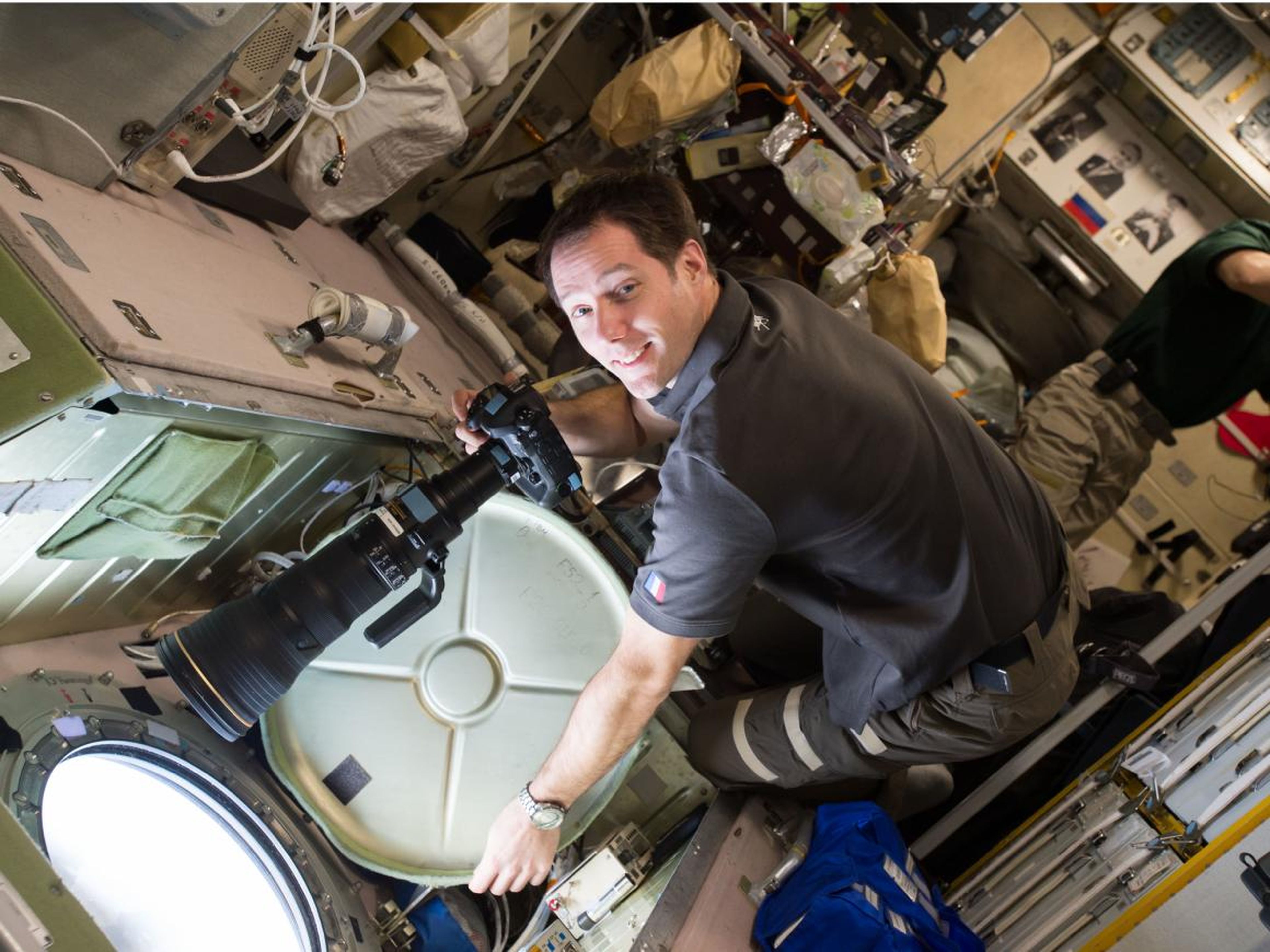 European Space Agency astronaut Thomas Pesquet preparing to take Crew Earth Observations photos from the Service Module window in December 2016.