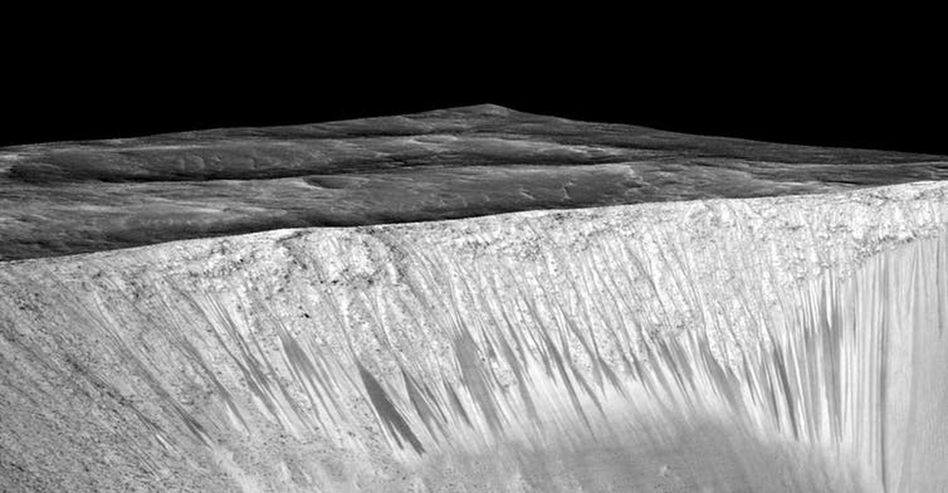 Los científicos sostienen la hipótesis de que las vetas estrechas y oscuras fueron formadas por agua líquida salada -necesaria para la vida- que fluye por las paredes de un cráter en Marte.