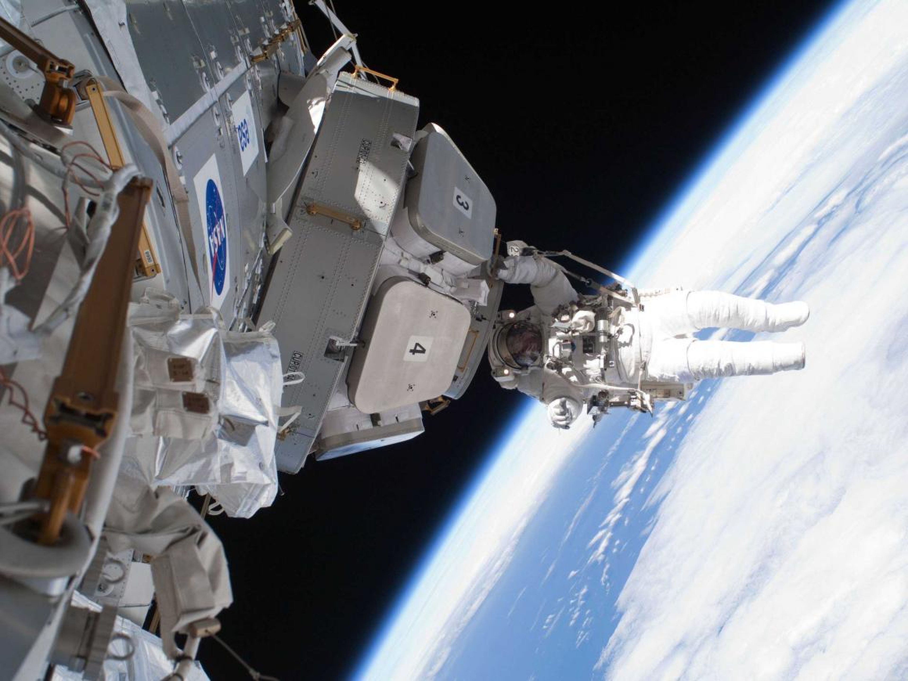 NASA astronaut Nicholas Patrick hangs on to Cupola, a module of the ISS built by the European Space Agency.