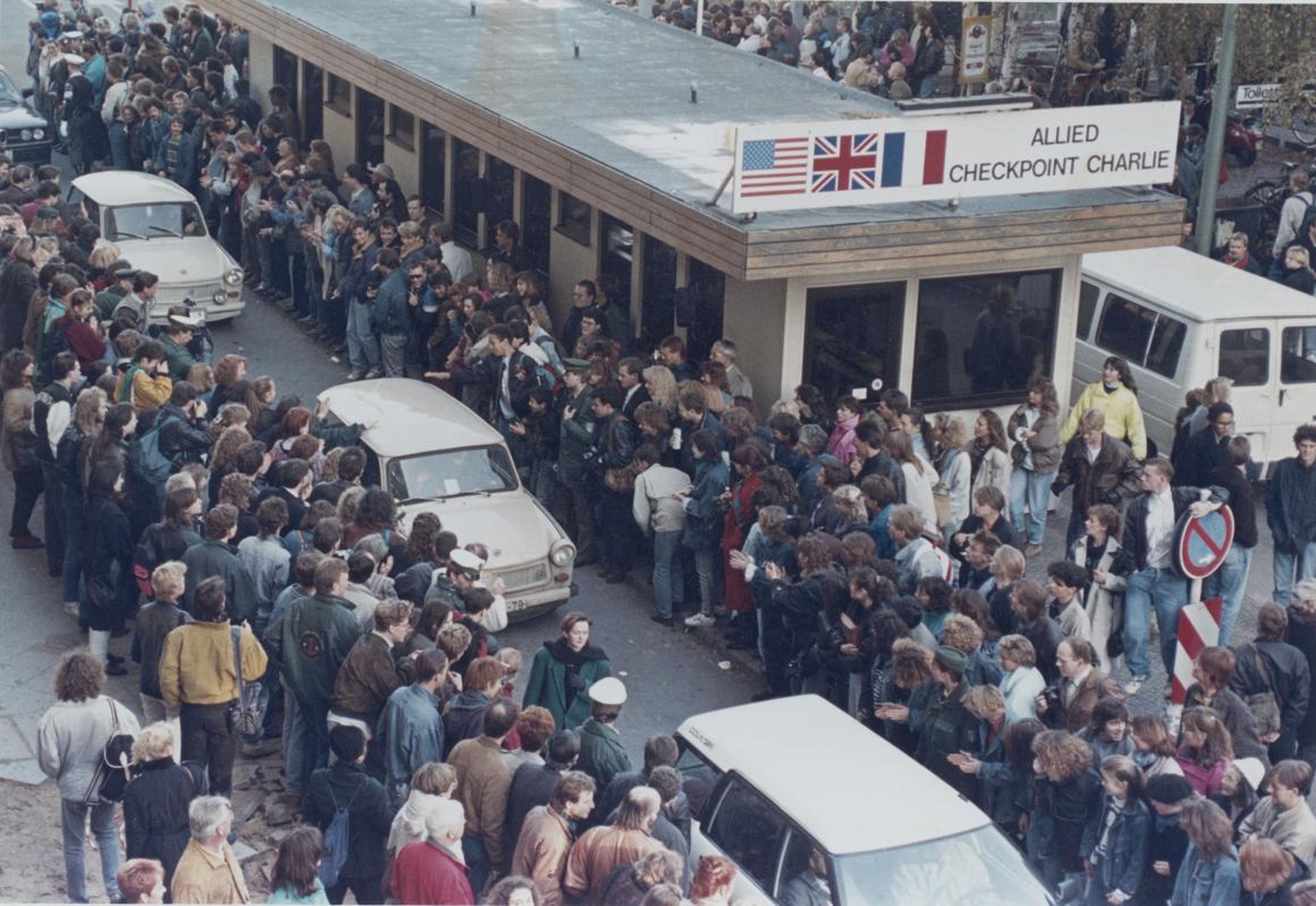 West Germans applauded as East Berlin citizens traveled through Checkpoint Charlie on the following day, November 10.