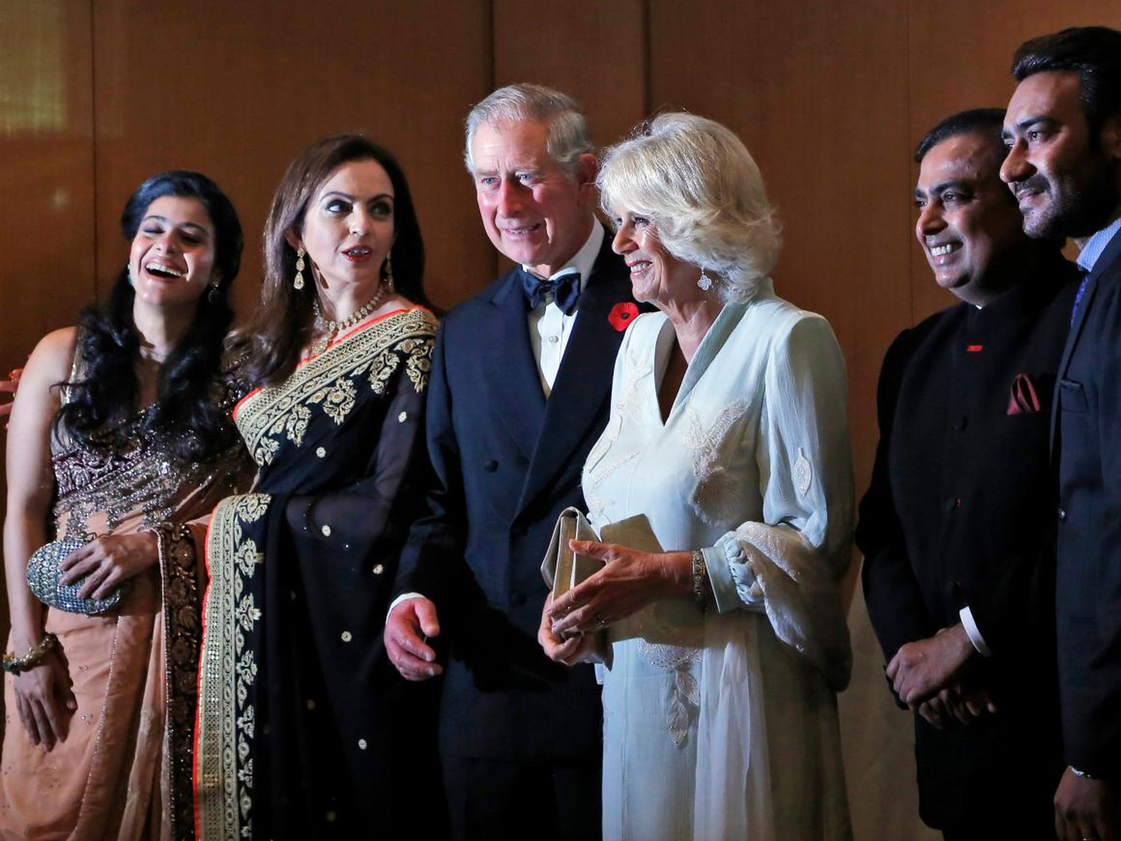 From left: actress Kajol, Nita Ambani, Britain's Prince Charles and his wife Camilla, the Duchess of Cornwall, Mukesh Ambani, and actor Ajay Devgan stand together before a dinner to support the work of British Asian Trust in Mumbai in 2013.