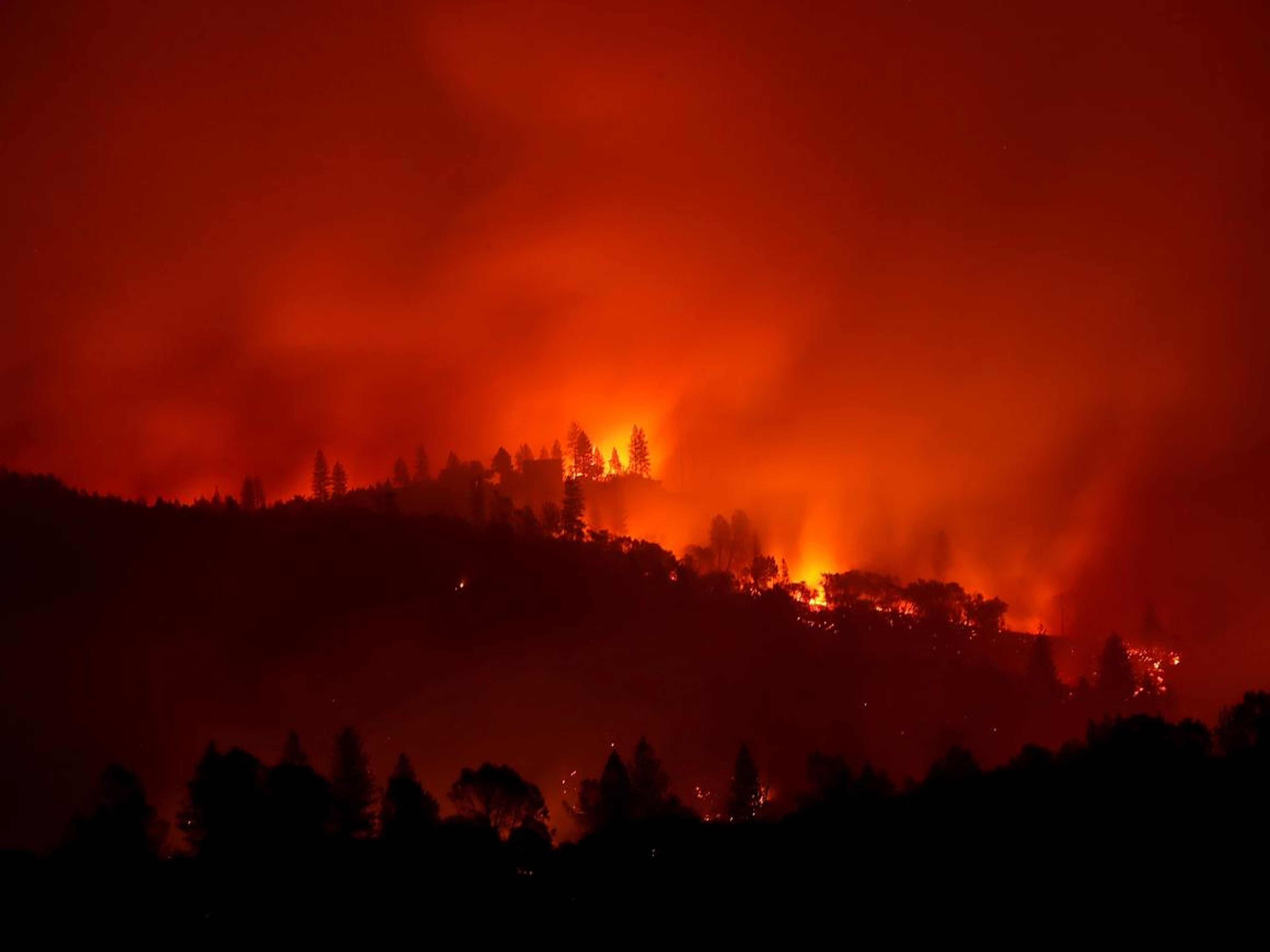 The Camp Fire burns in the hills near Ororville, California.