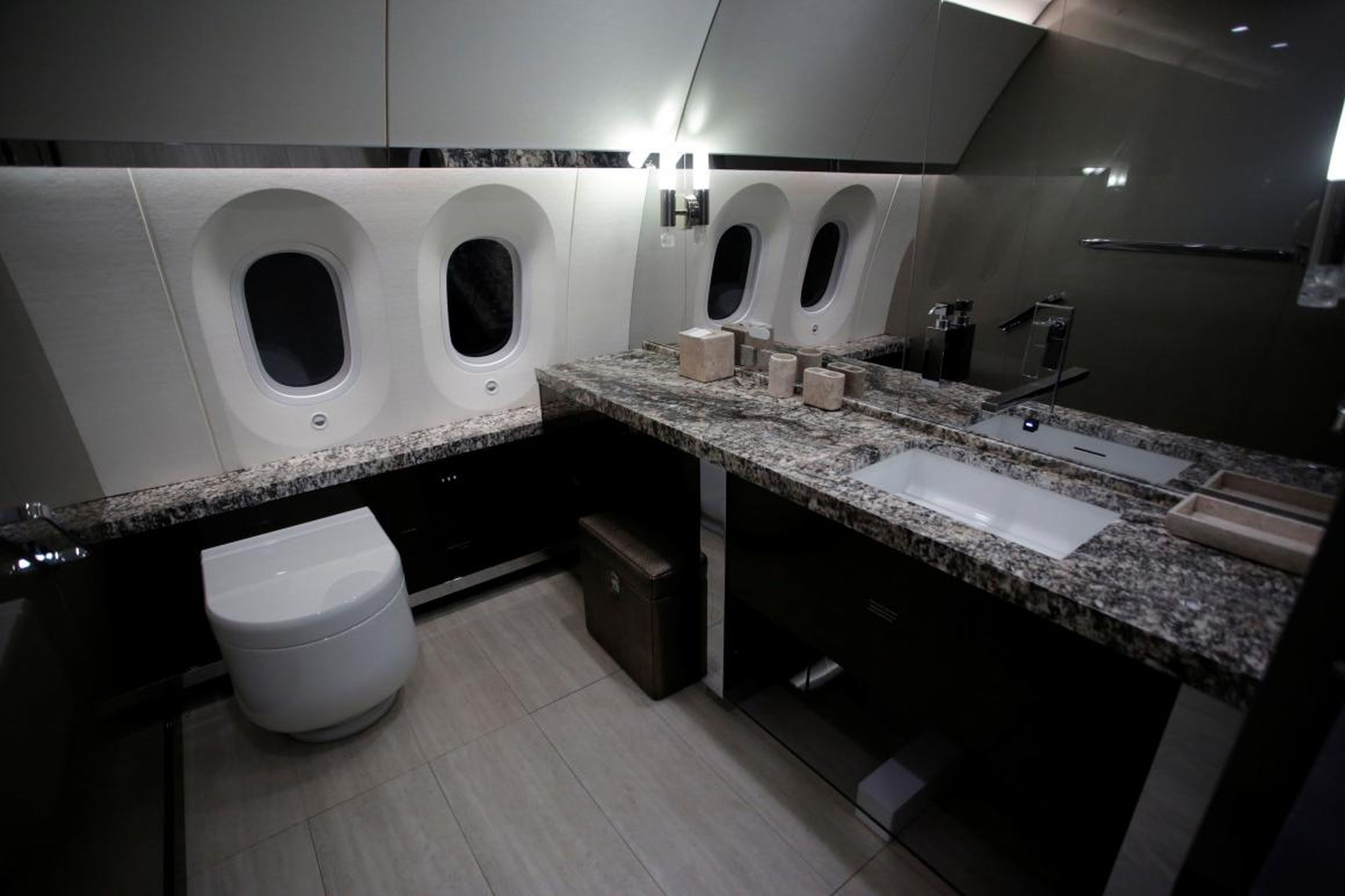 Here is a look at a restroom on the plane complete with stone countertops.