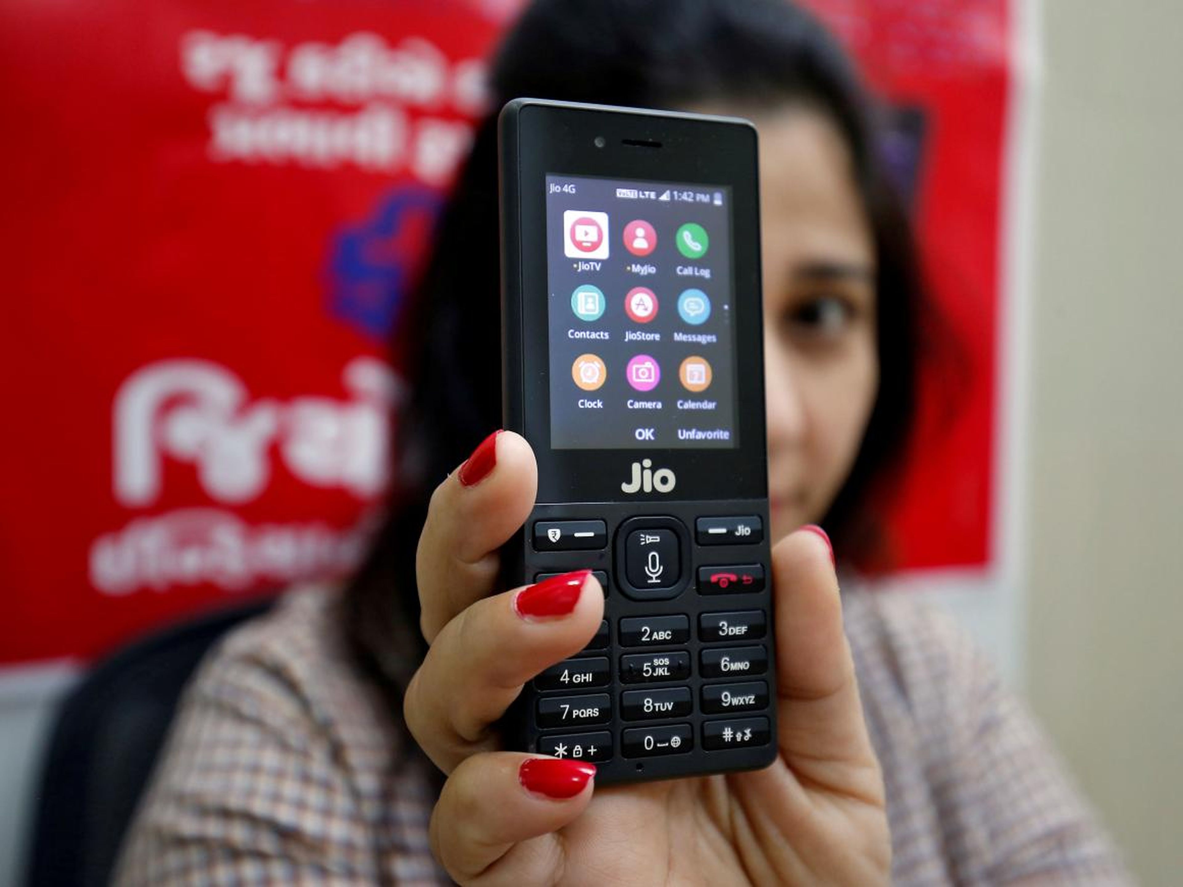 A sales person displays a JioPhone on the outskirts of Ahmedabad, India.