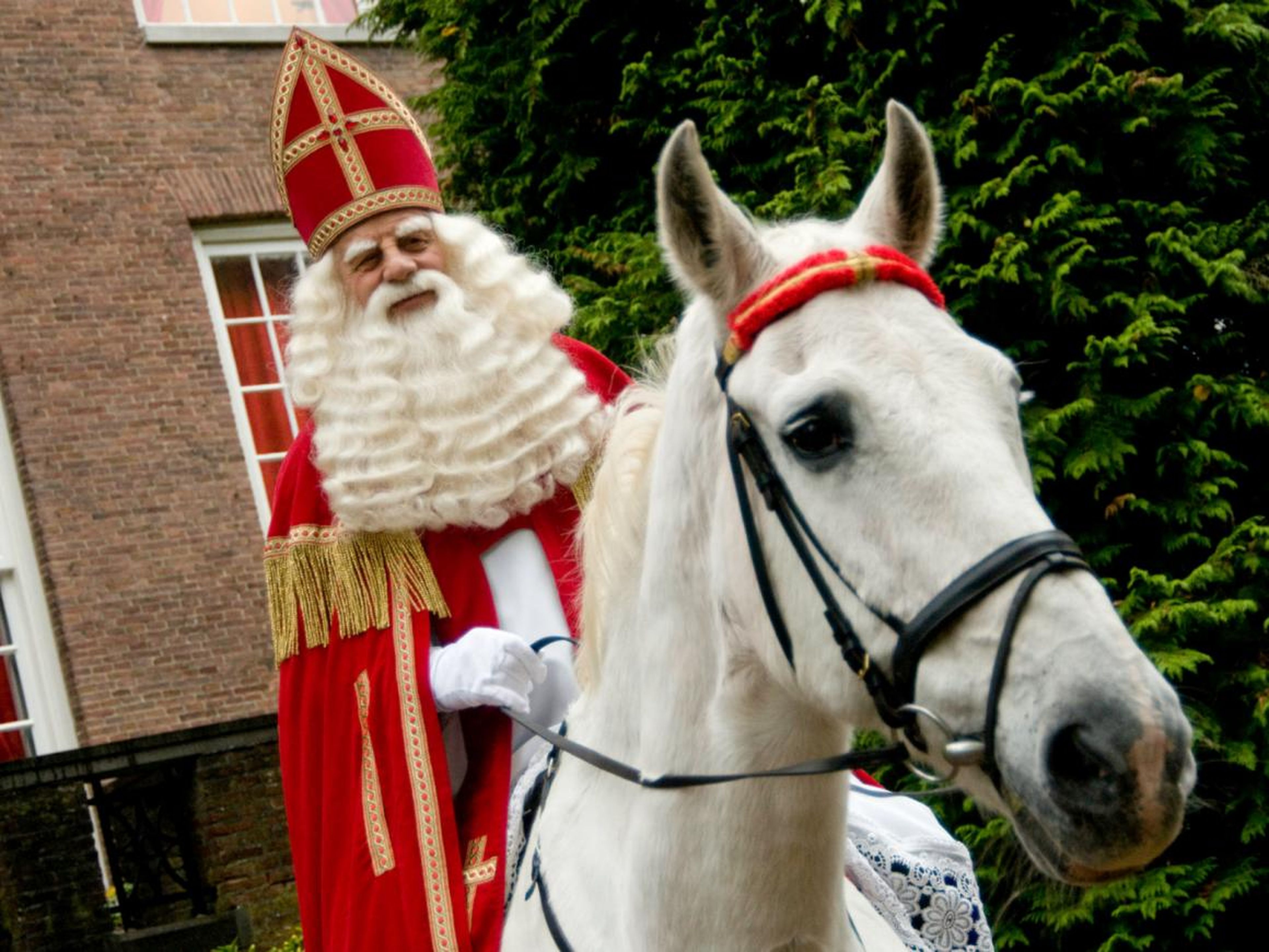 Sinterklaas rides on his horse outside the Het Loo Palace in the Netherlands.