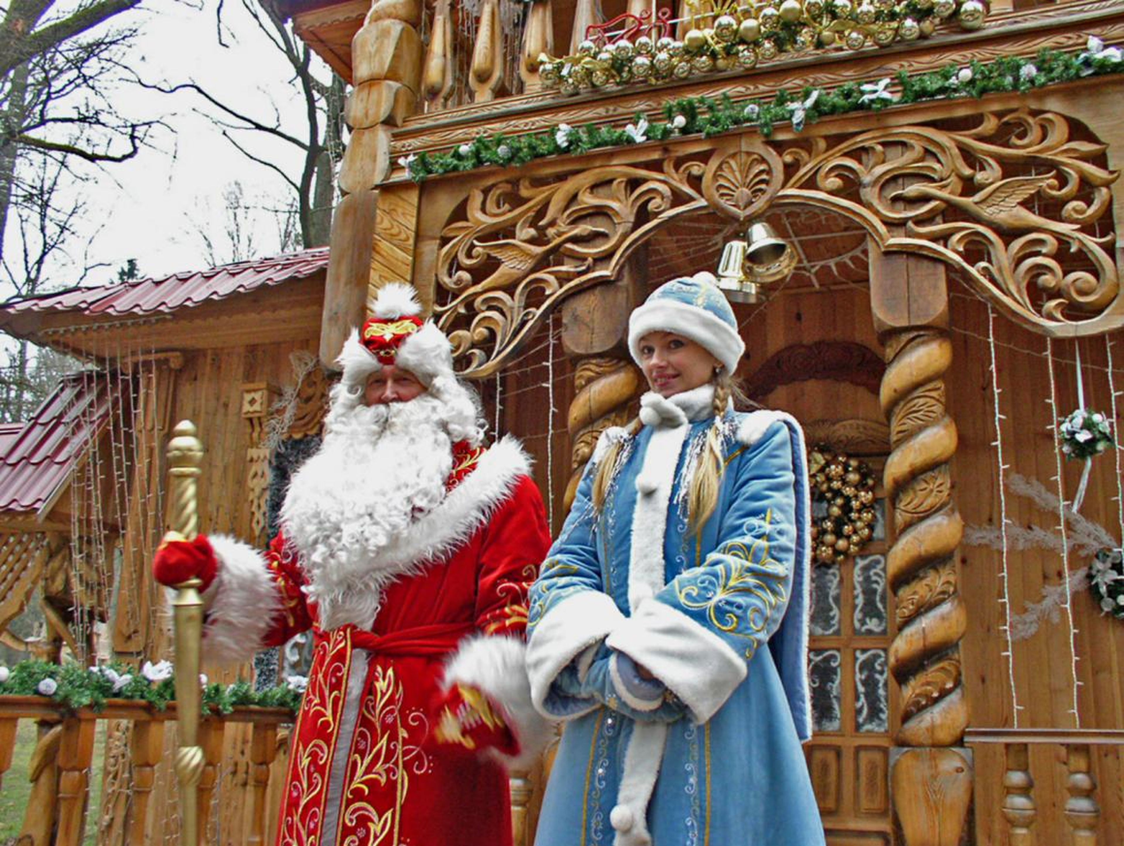 Ded Moroz poses with the Snow Maiden at a Christmas festival in Russia.