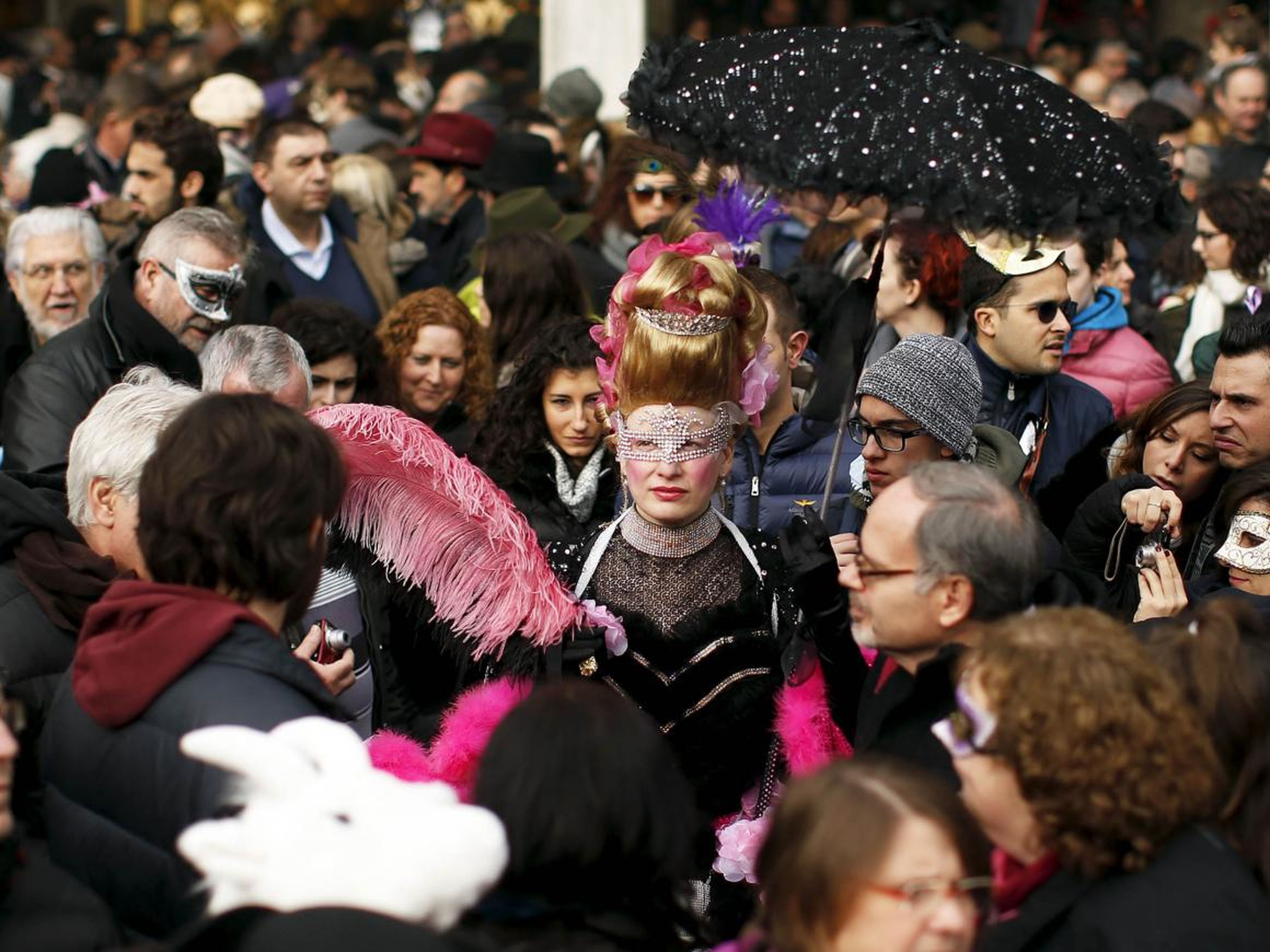 The two-week long event brings thousands of people to the city each year to don masks and costumes and party in the streets.