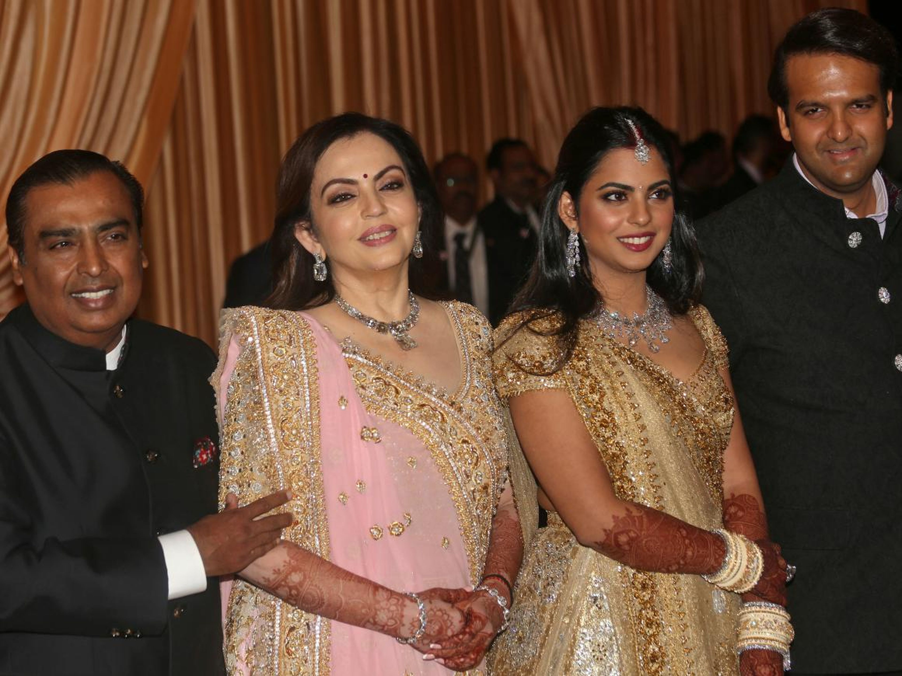 Mukesh Ambani and Nita Ambani with Isha Ambani and her new husband at their wedding reception in Mumbai.
