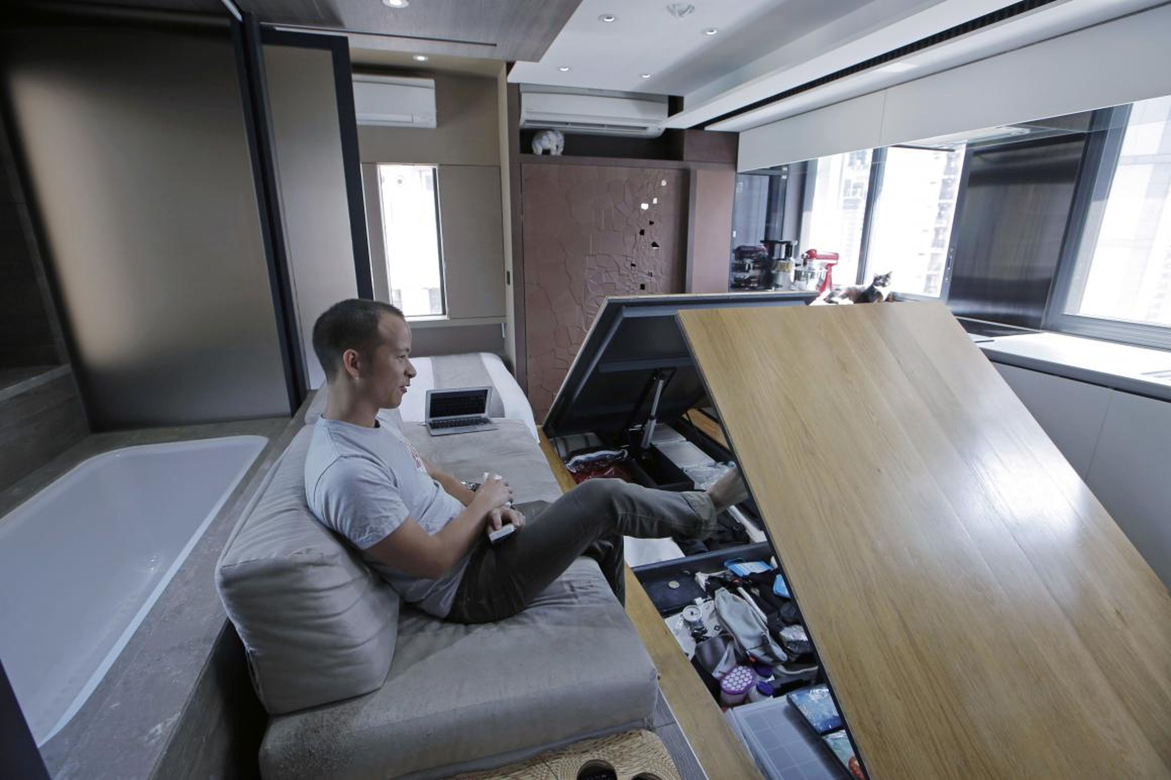 Andy Knight reveals hidden storage compartments in his Hong Kong microapartment.