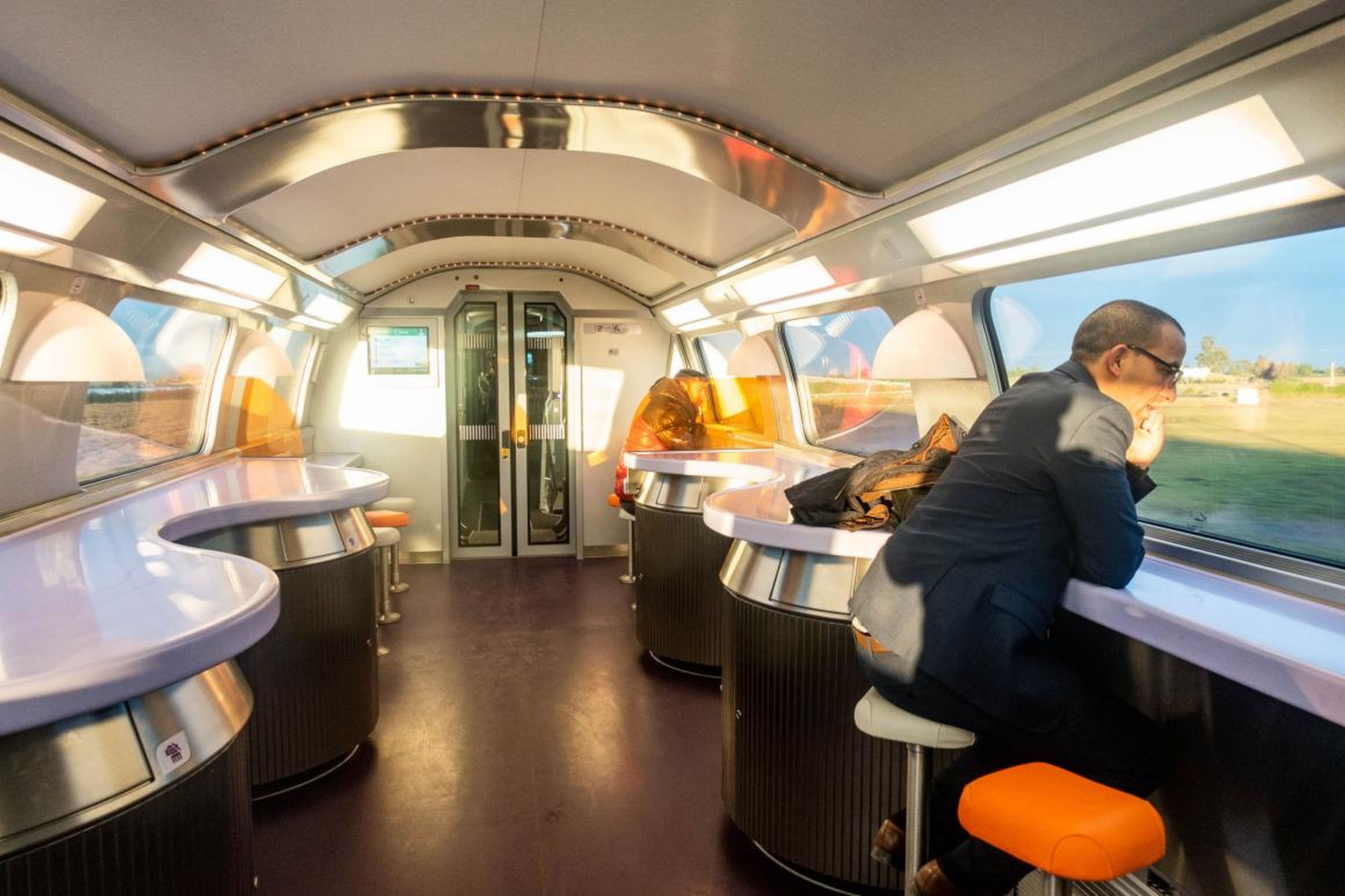 The cafeteria car had a retro but futuristic vibe with its curved ceilings, wavy bar table, and colorful stools.
