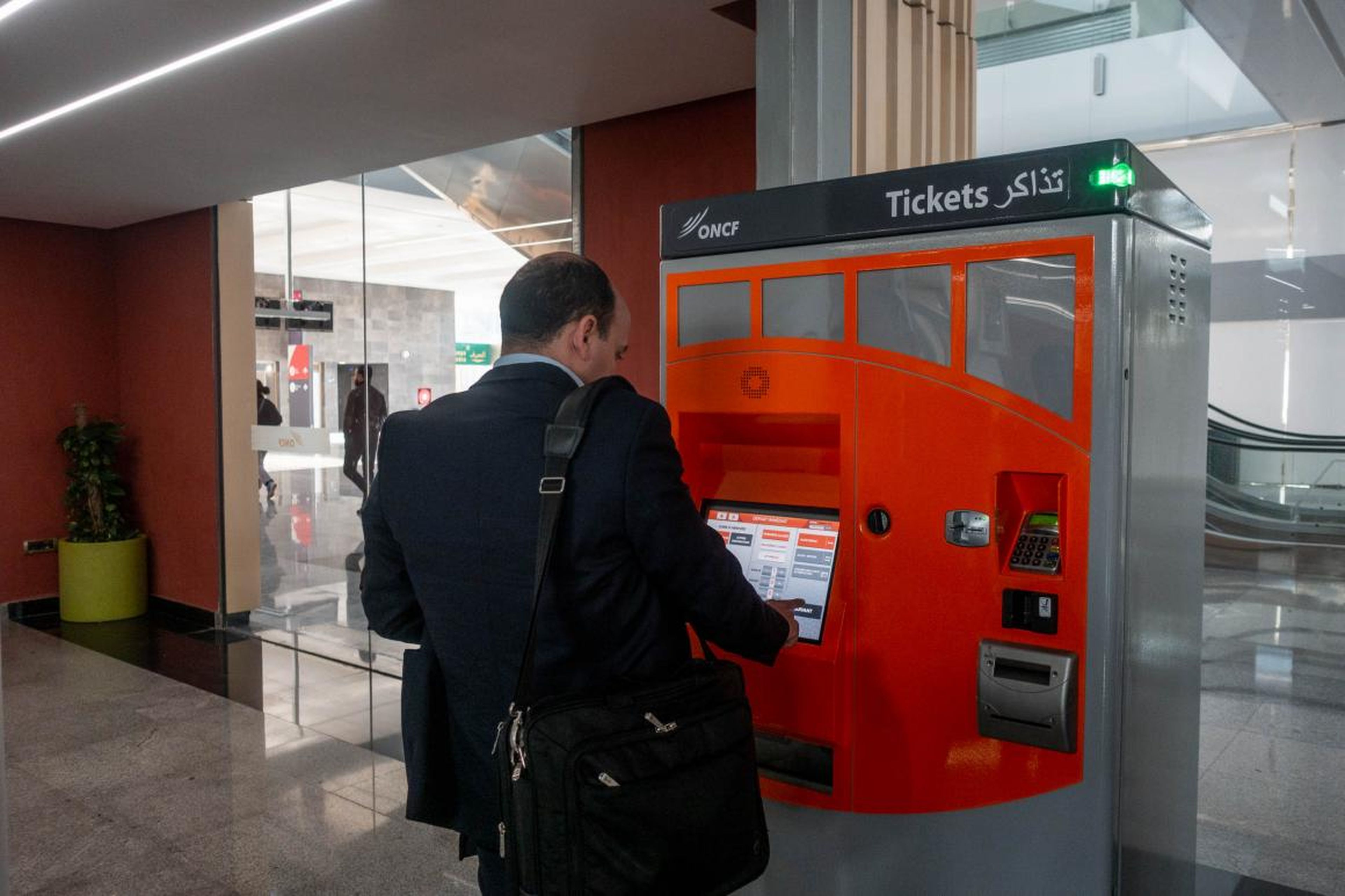 The machines are easy enough to use. Anyone who has visited a major city and used the metro system can figure it out. It accepts cash and credit cards.