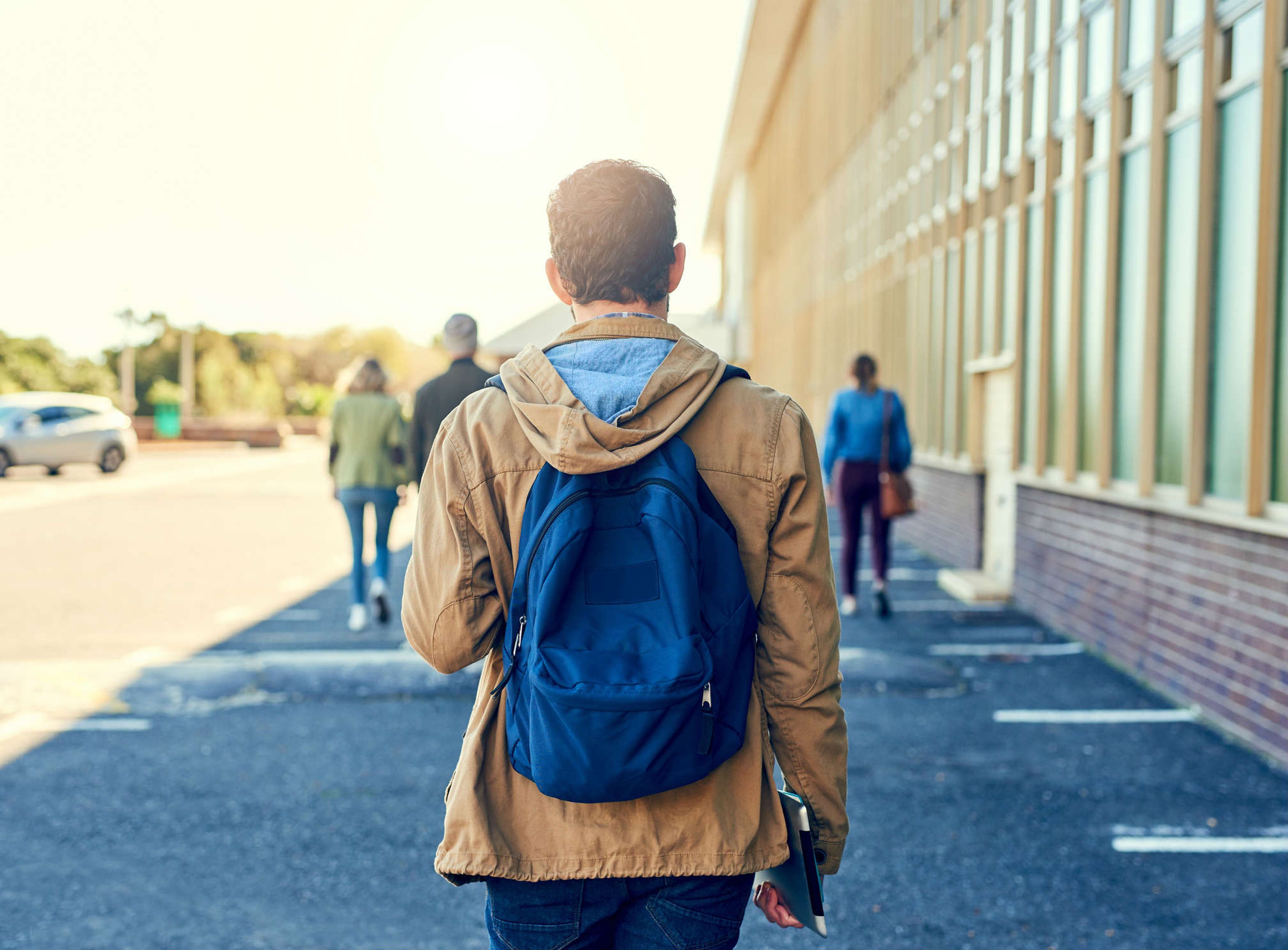 Un joven camina con su mochila a la espalda