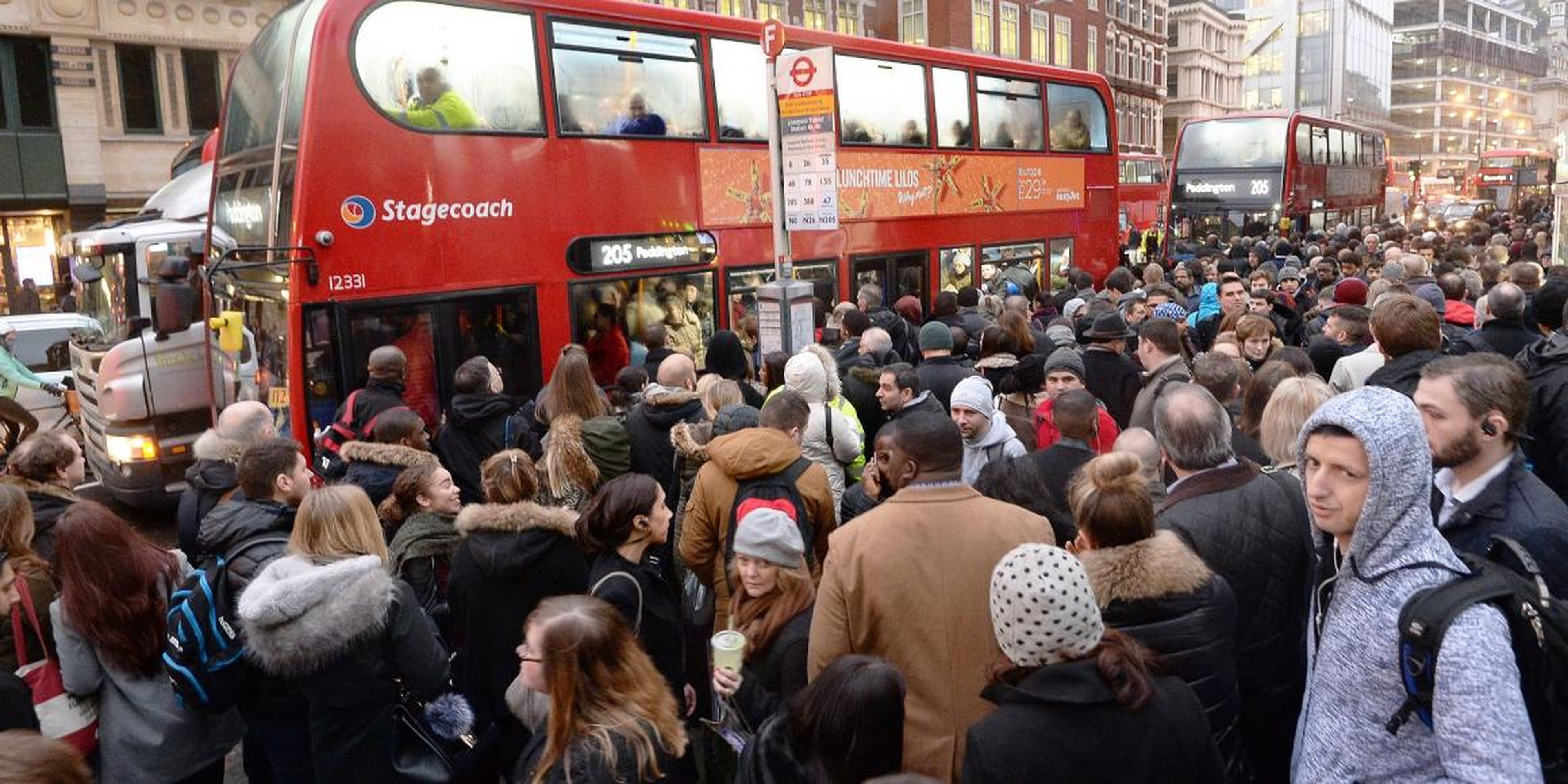 People queue for buses at Bishopsgate in the City of London, as Underground workers in the capital continued a 24-hour strike which crippling Tube services and causing travel chaos for millions of passengers.