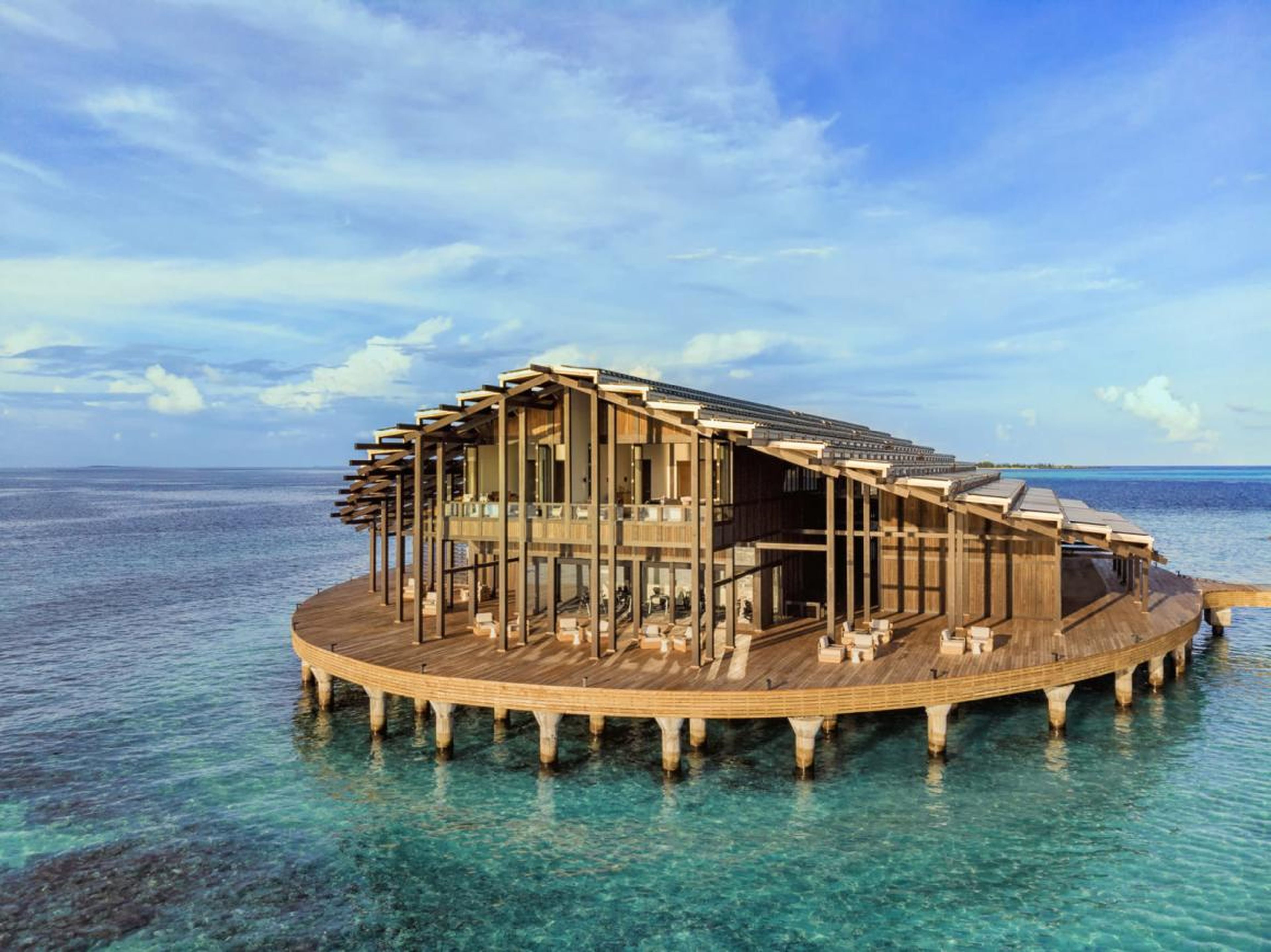 The resort consists of 15 bungalows that arch out over the water in a circular shape.