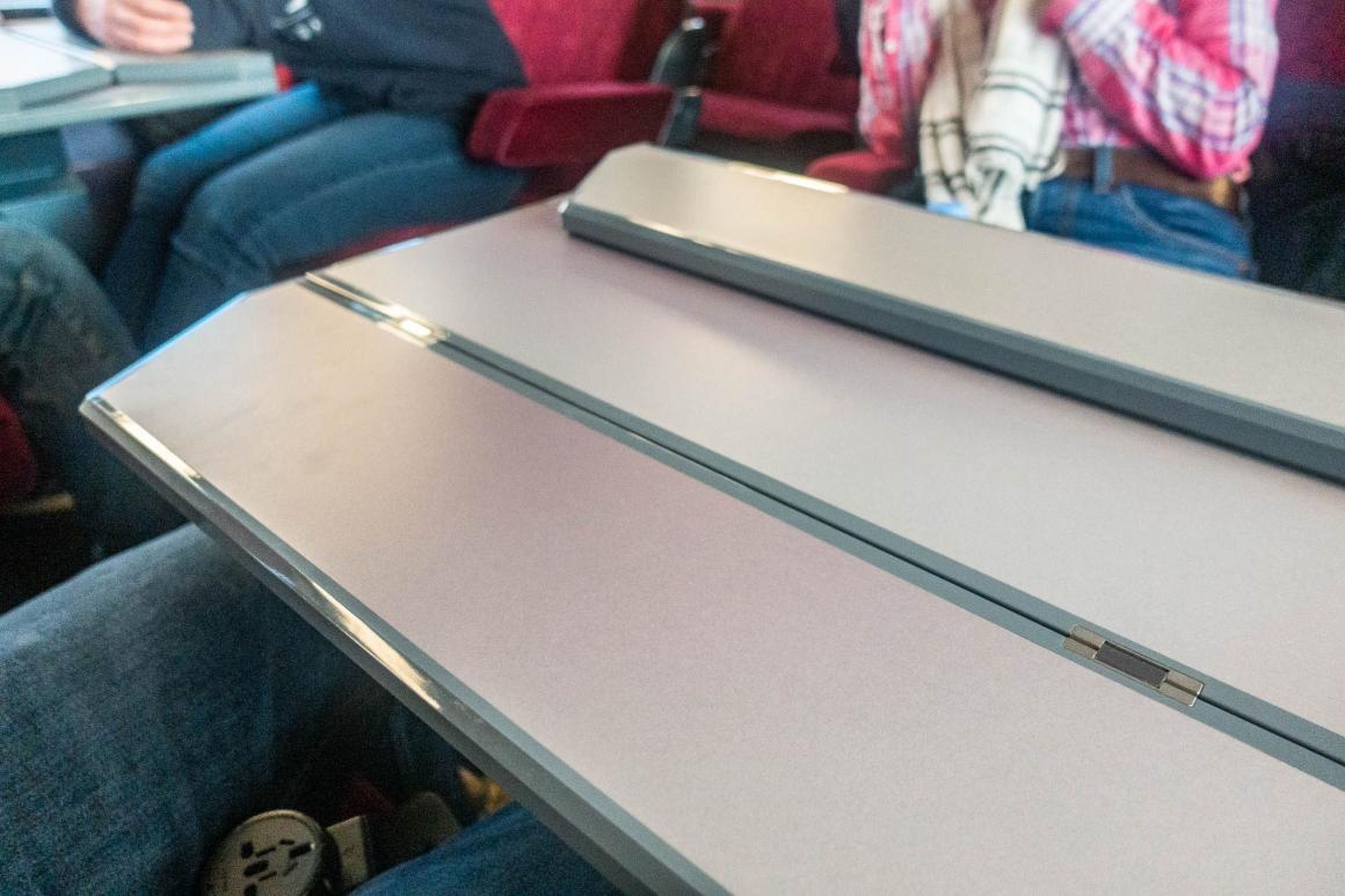 The tray table on the double rows folds out for each person. It's a much roomier table than you'd typically get on an airplane.