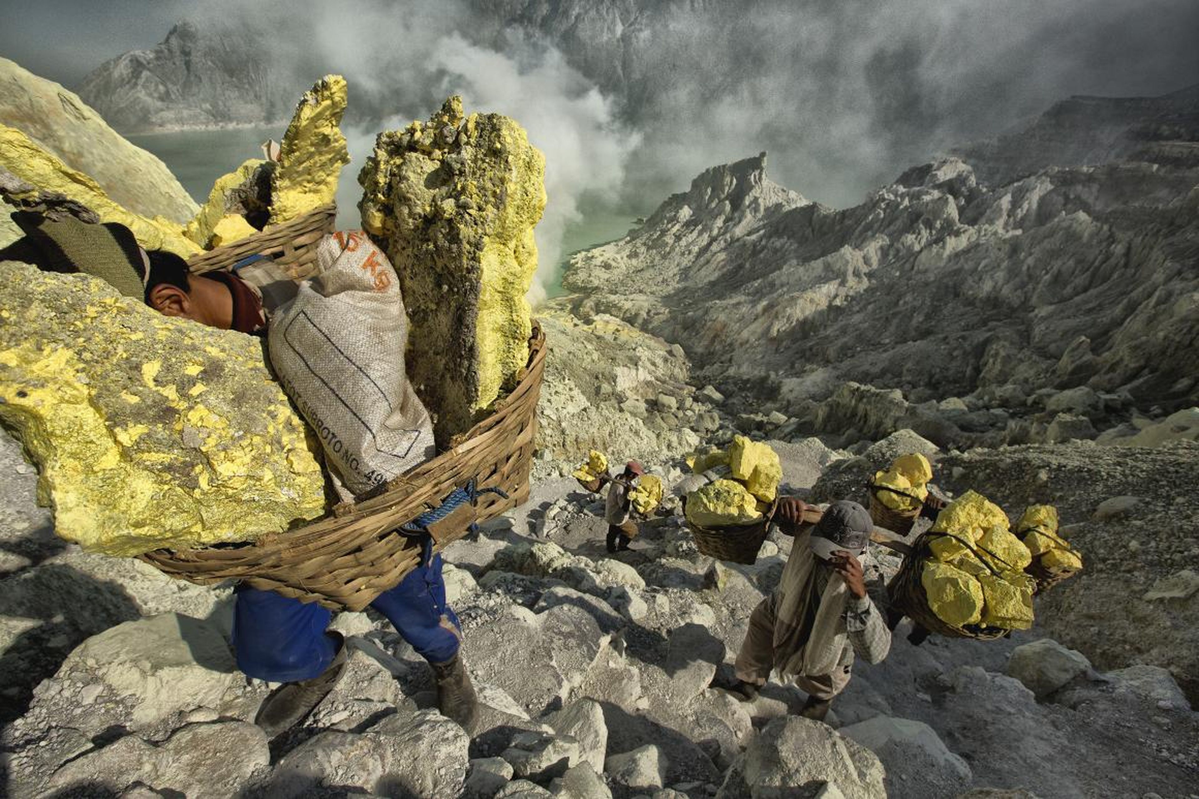 1. Sulfur miners in Indonesia work inside an active volcano, where they carry around 154-pound loads a half mile out of the volcano, and then two more miles down the mountain to a weigh station.