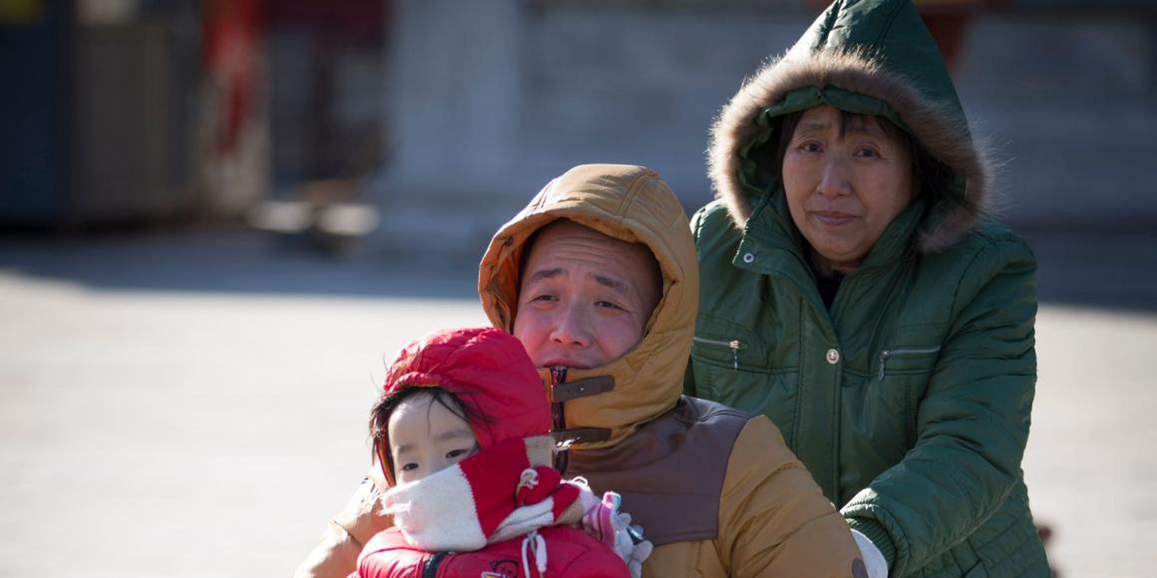 Chinese citizens spend time with their grandchild in Beijing in March 2014. Taking care of the elderly can get you good credit in some parts of China.