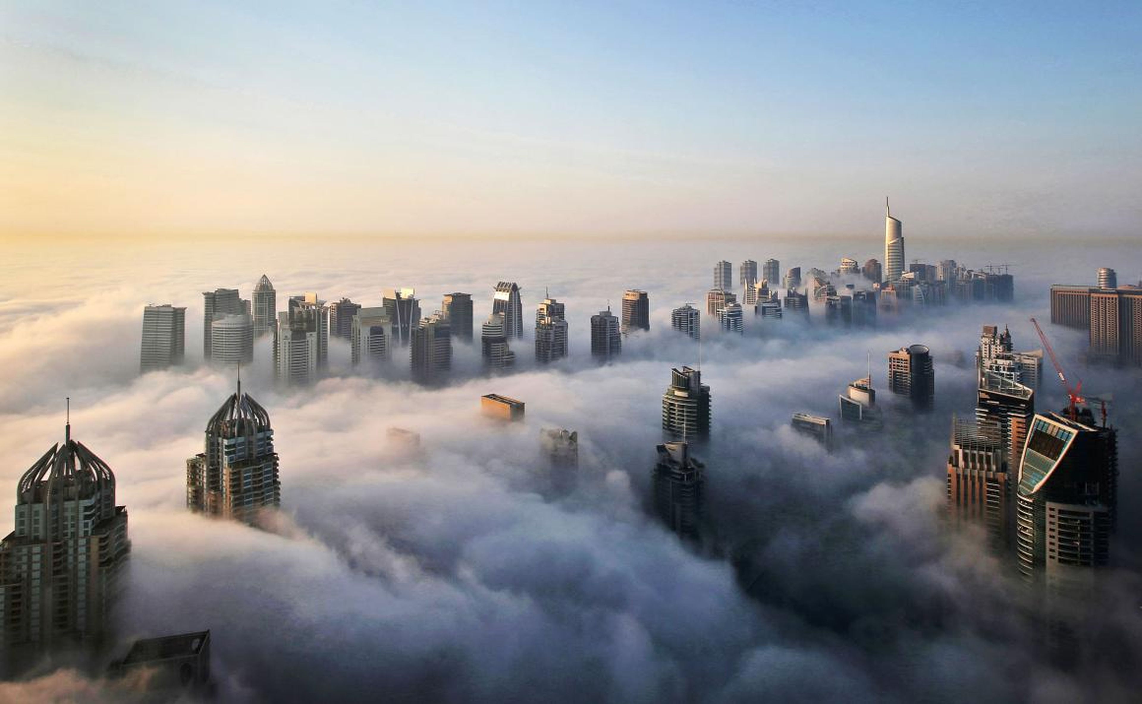 Buildings poke through clouds in Dubai.